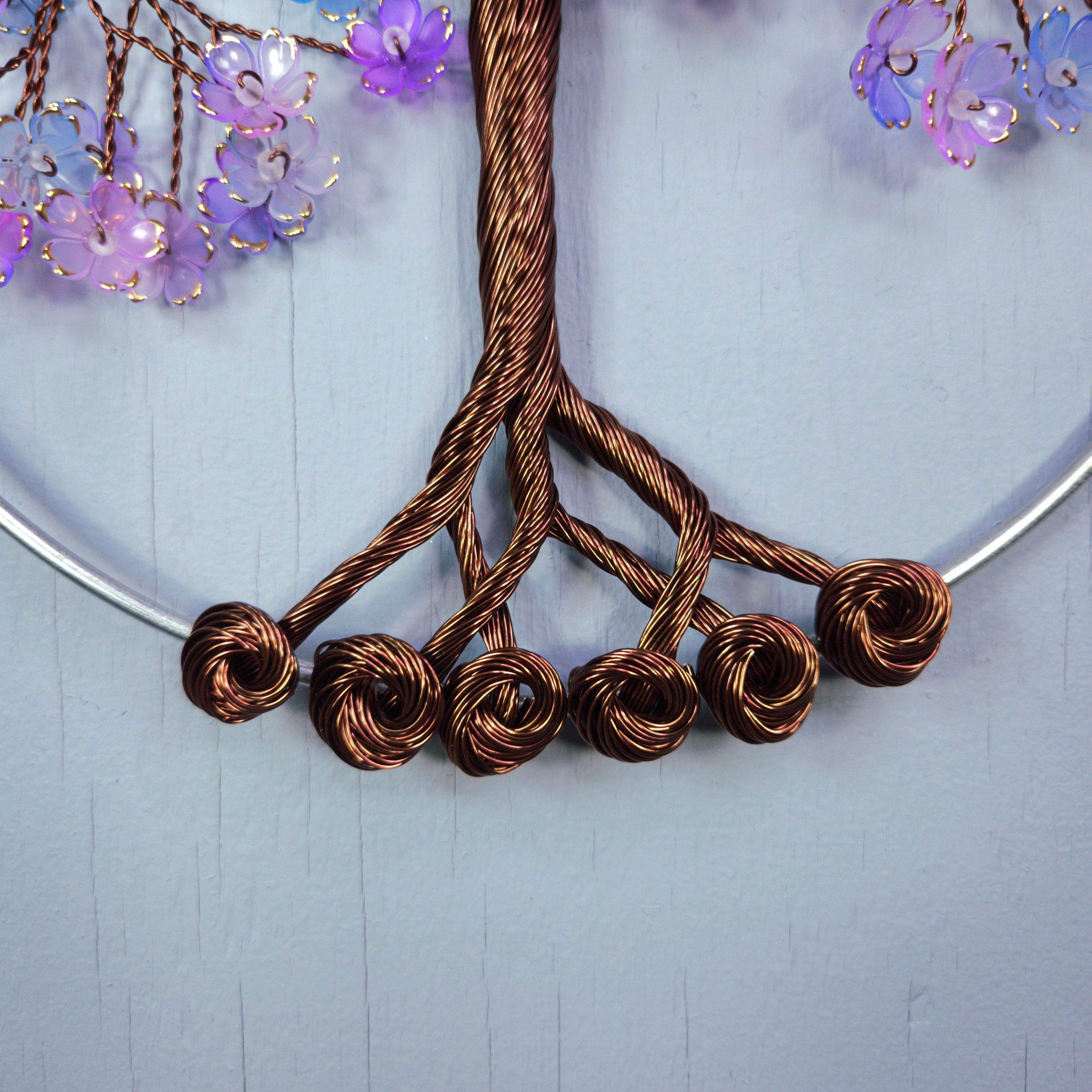 Necklace with brown knotted design on a light blue background