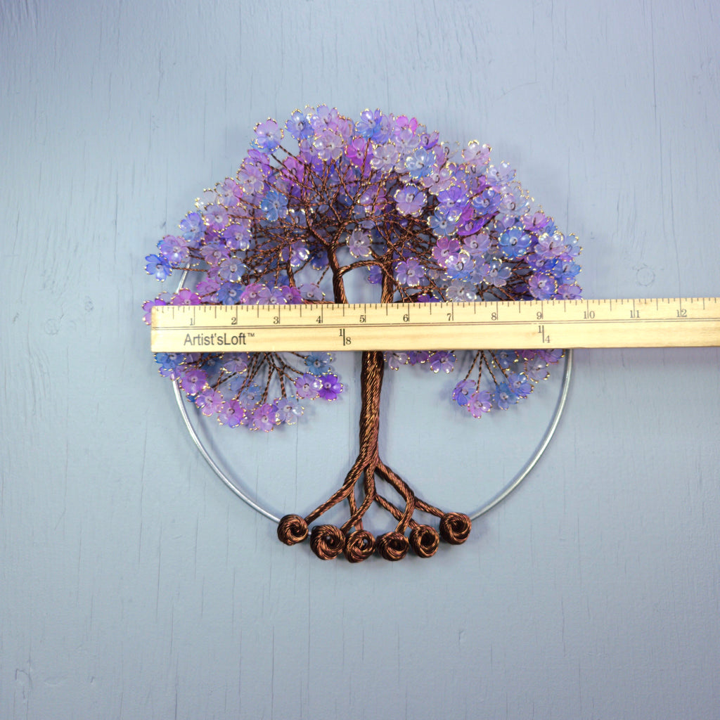 Decorative tree wall art with purple flowers and brown trunk, measured against a ruler on a light blue background.
