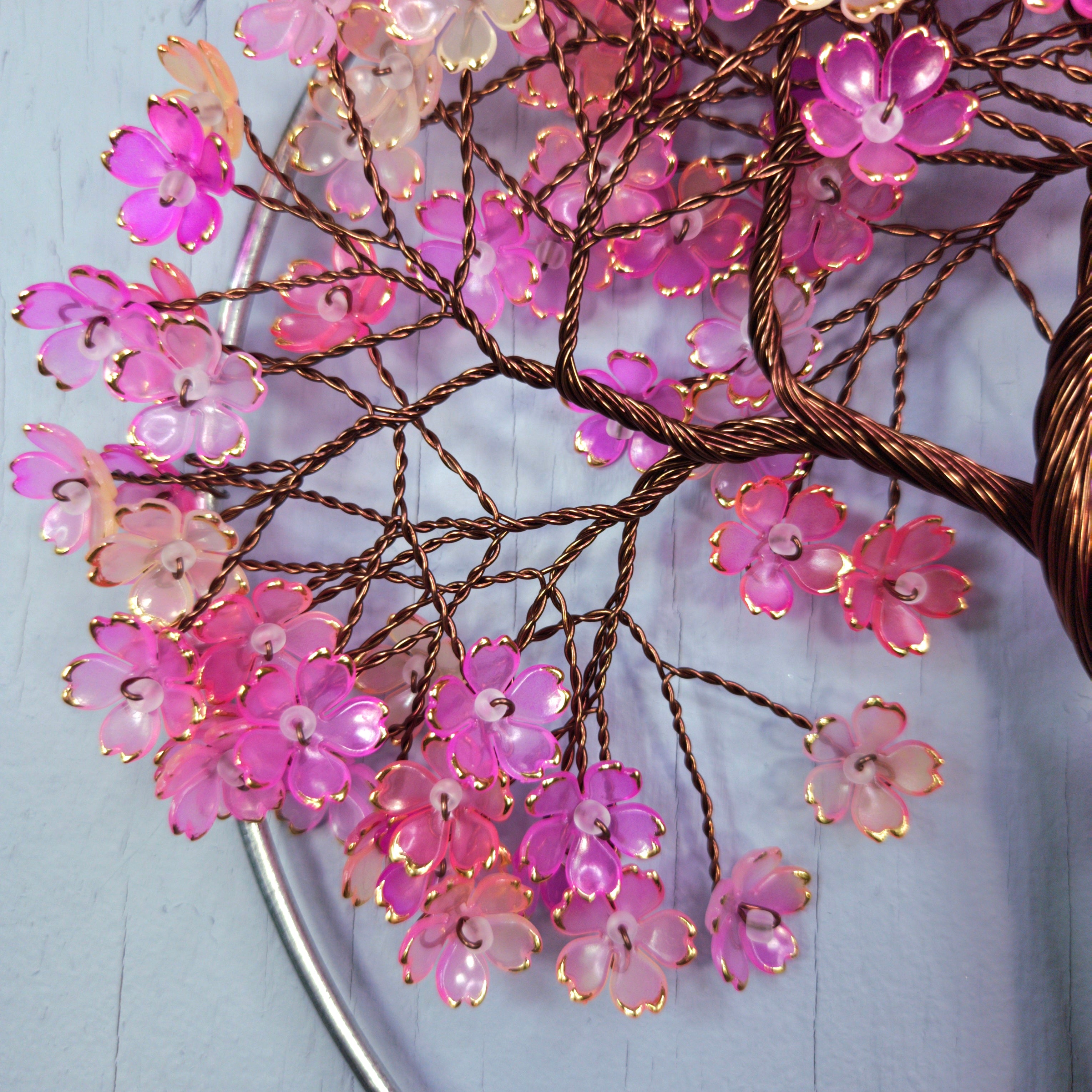 Decorative branch with pink flowers on a light blue background