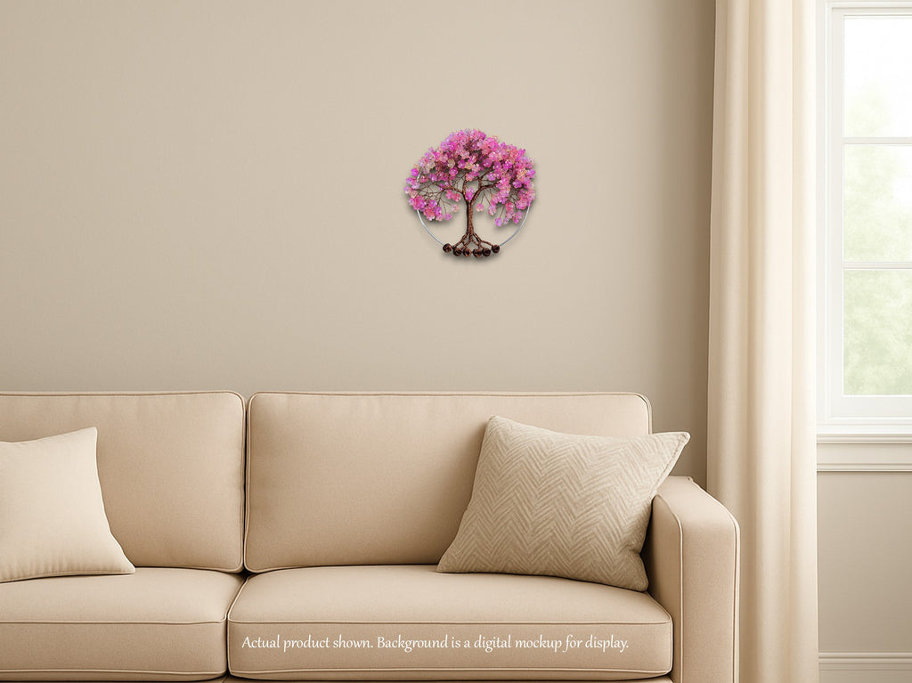 Decorative wall piece of a pink tree on a beige wall above a beige sofa.