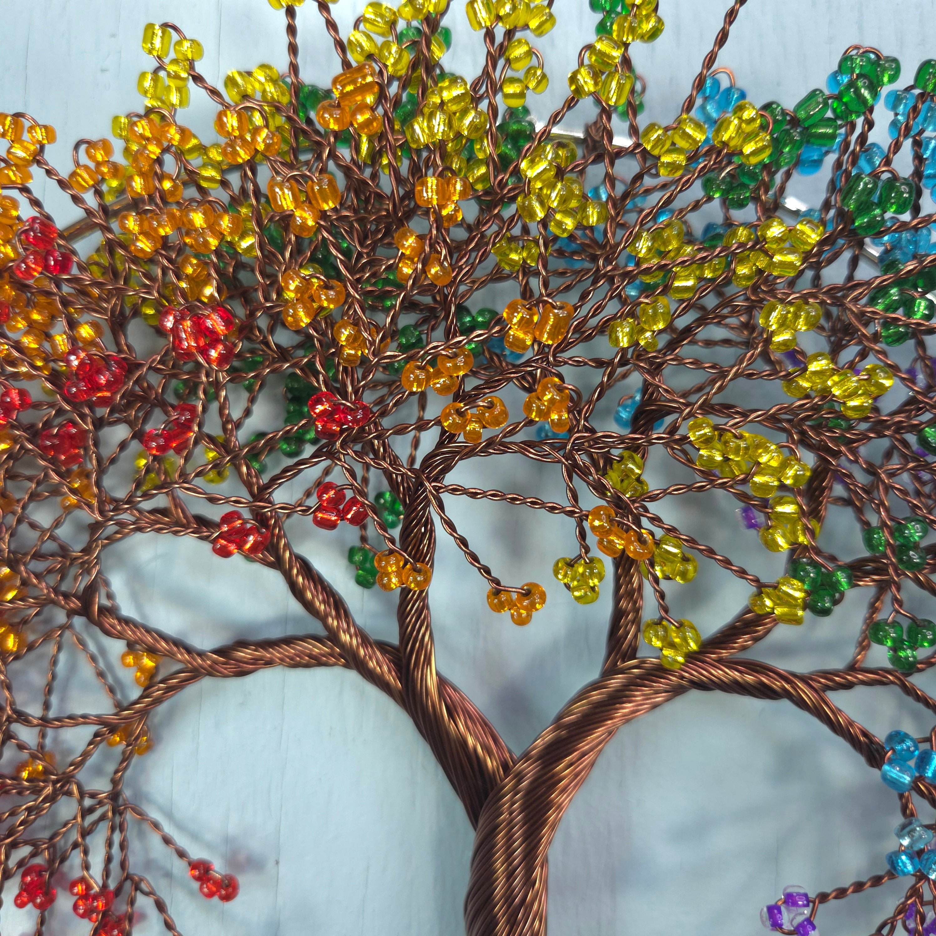 Decorative tree made of wire and beads with a white background