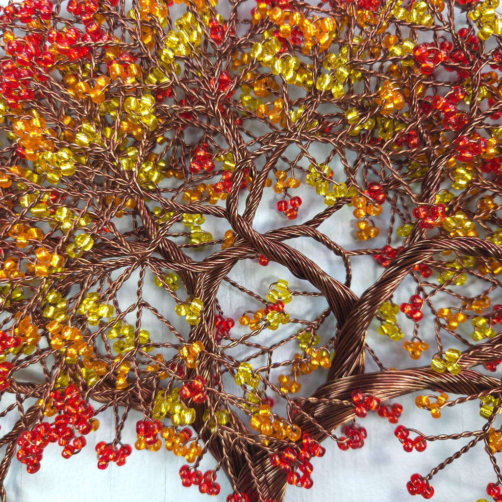Decorative wreath with red, yellow, and brown berries on a textured background