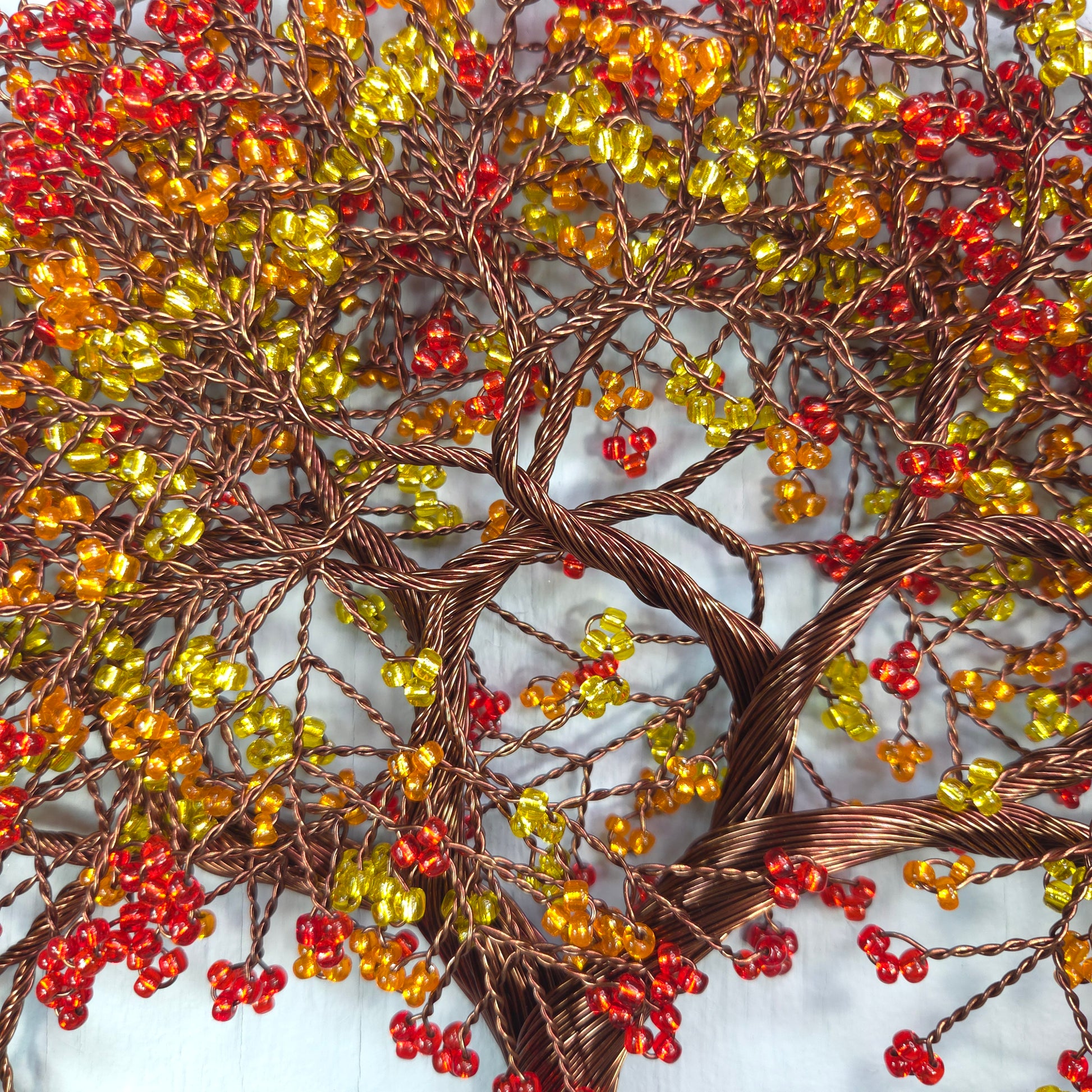 Decorative wreath with red, yellow, and brown berries on a textured background