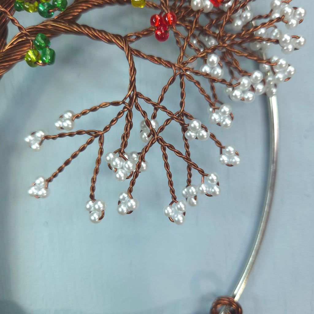 Decorative branch with beads on a light blue background