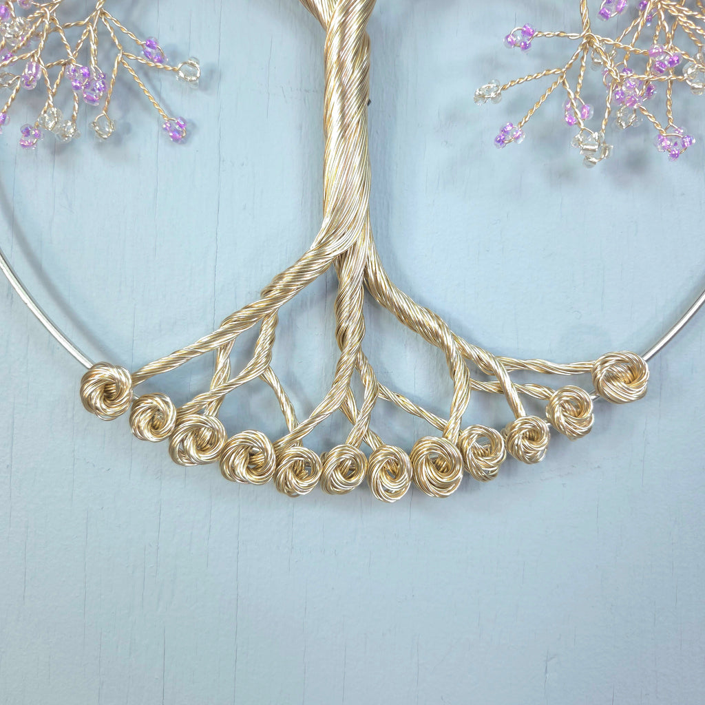 Gold necklace with floral design on a light blue background