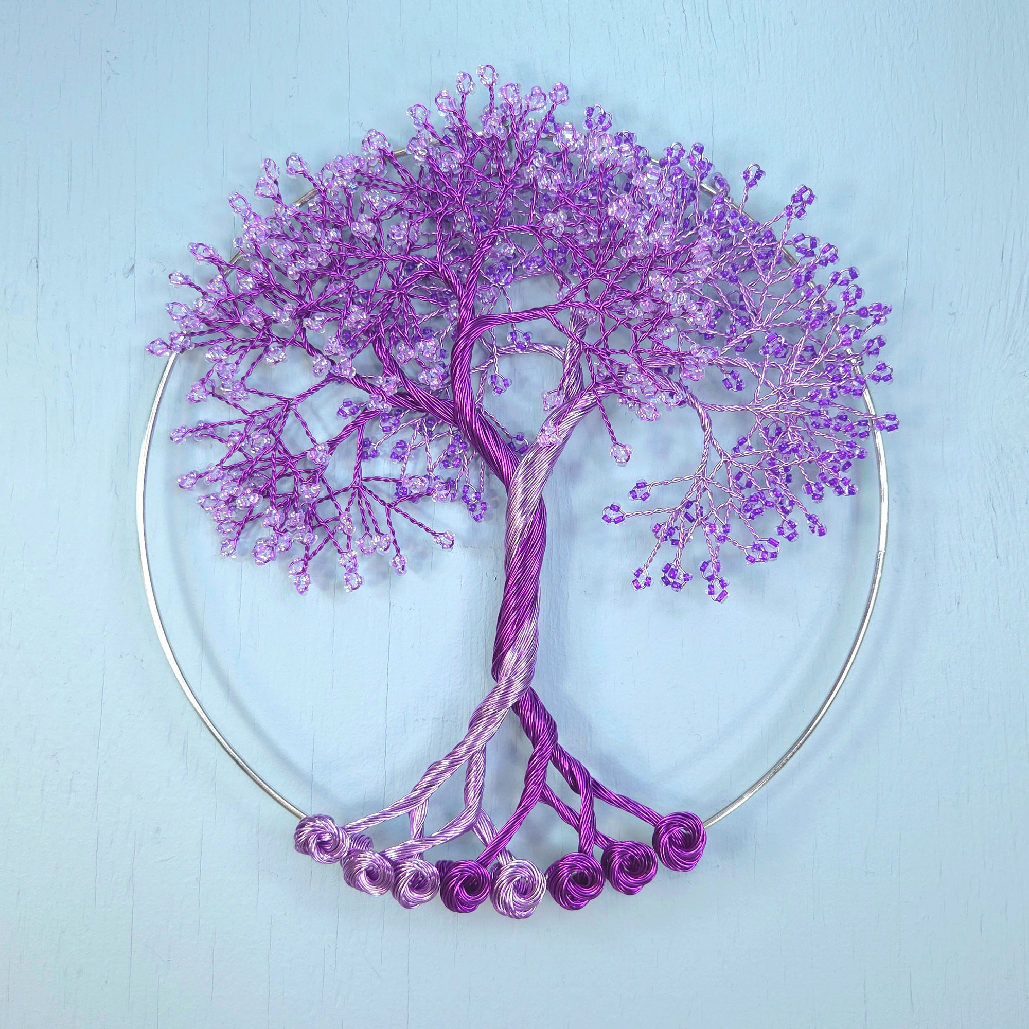 Decorative purple tree sculpture on a light blue background