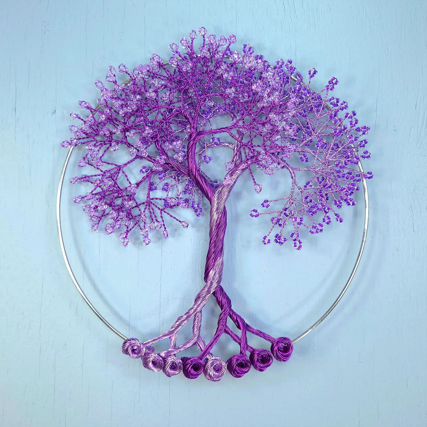 Decorative purple tree sculpture on a light blue background