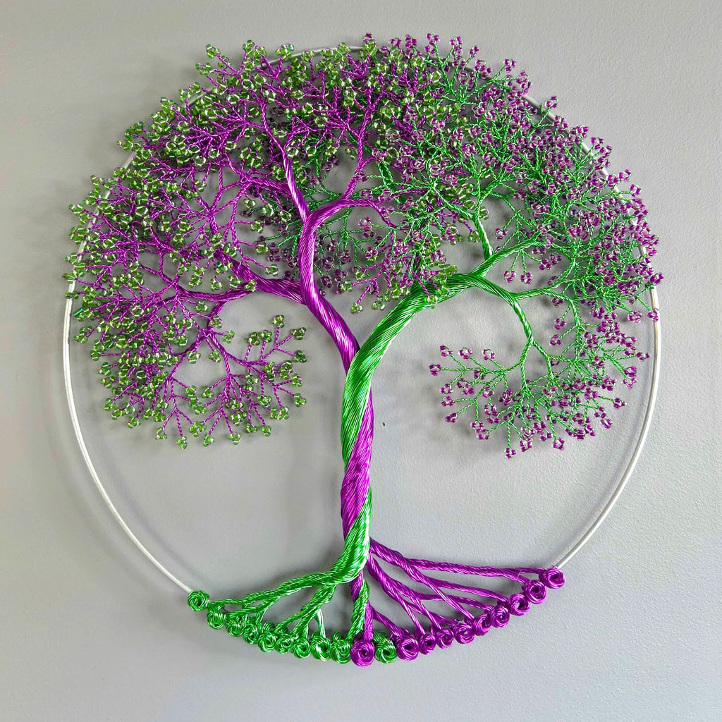 Decorative wall art of a tree with purple and green branches on a light gray background
