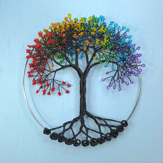 Colorful tree of life wall art on a light blue background
