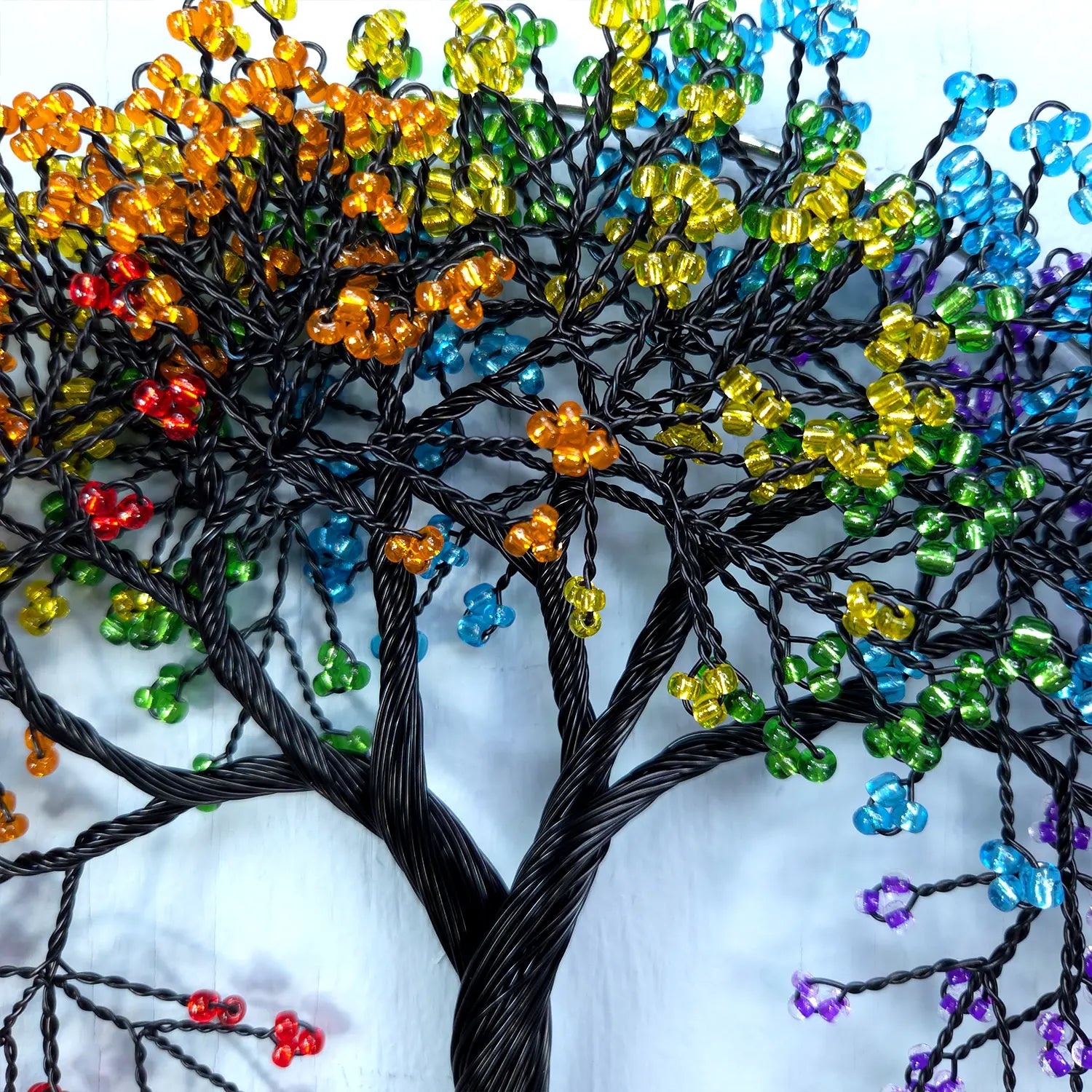 Colorful beaded tree against a white background