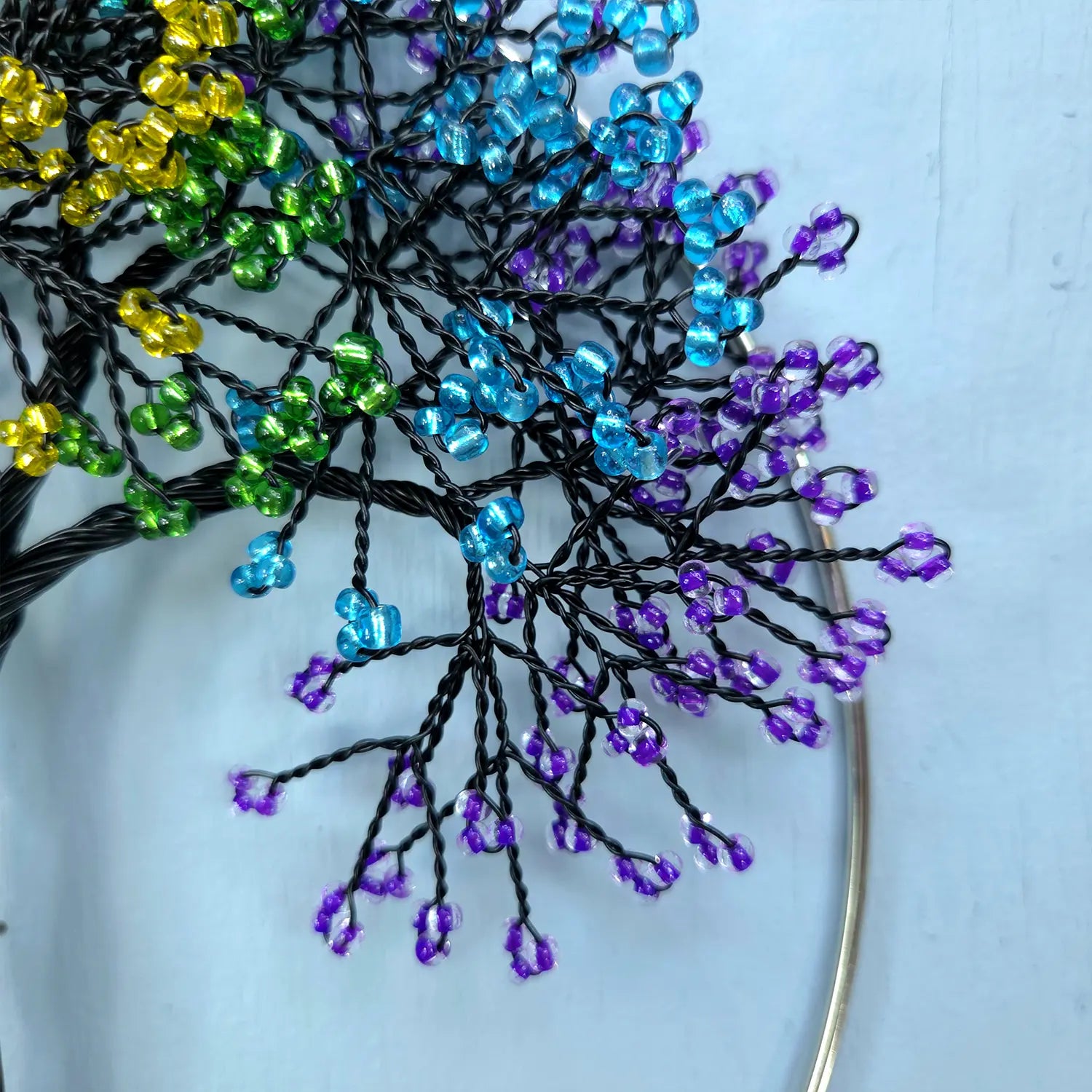 Decorative branch with colorful beads on a white background