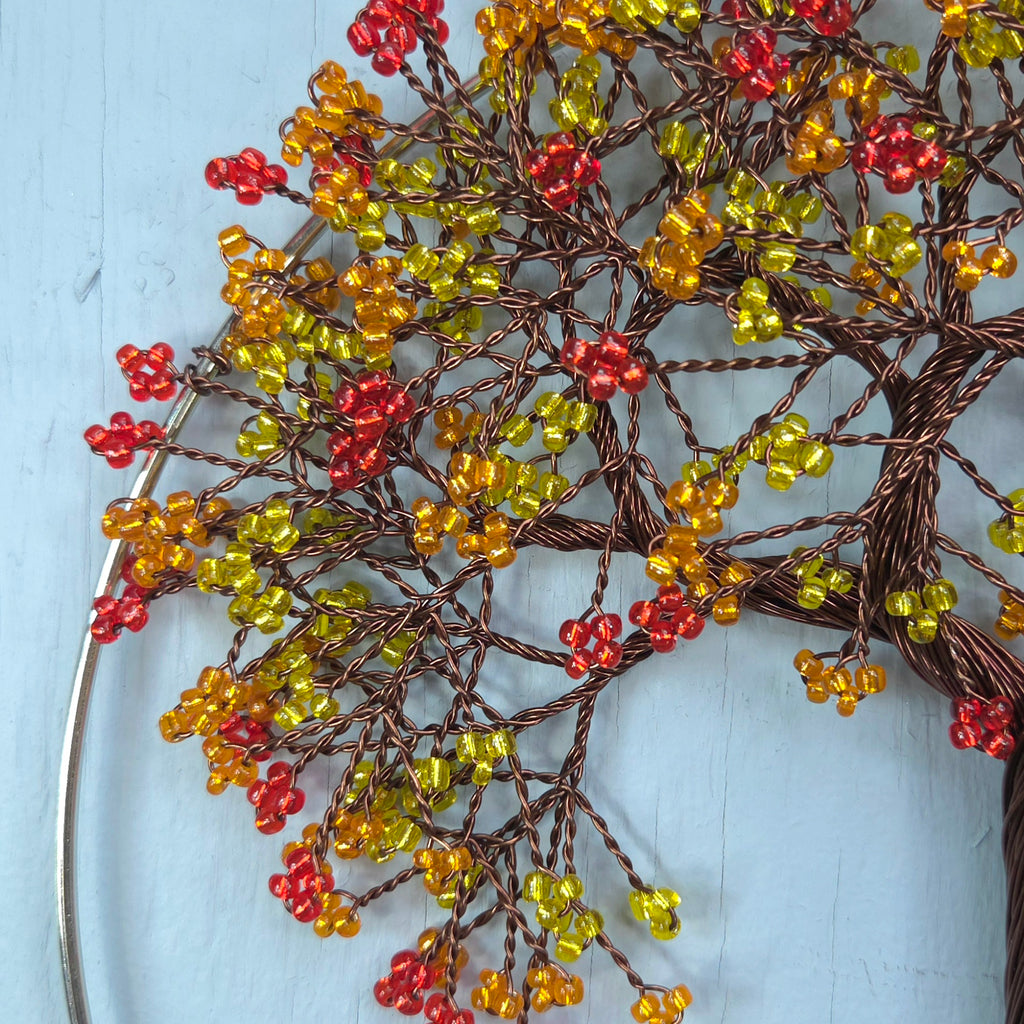 Decorative wreath with red and yellow berries on a light blue background