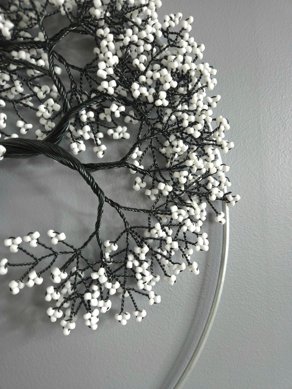 Decorative wreath with white berries on a plain background