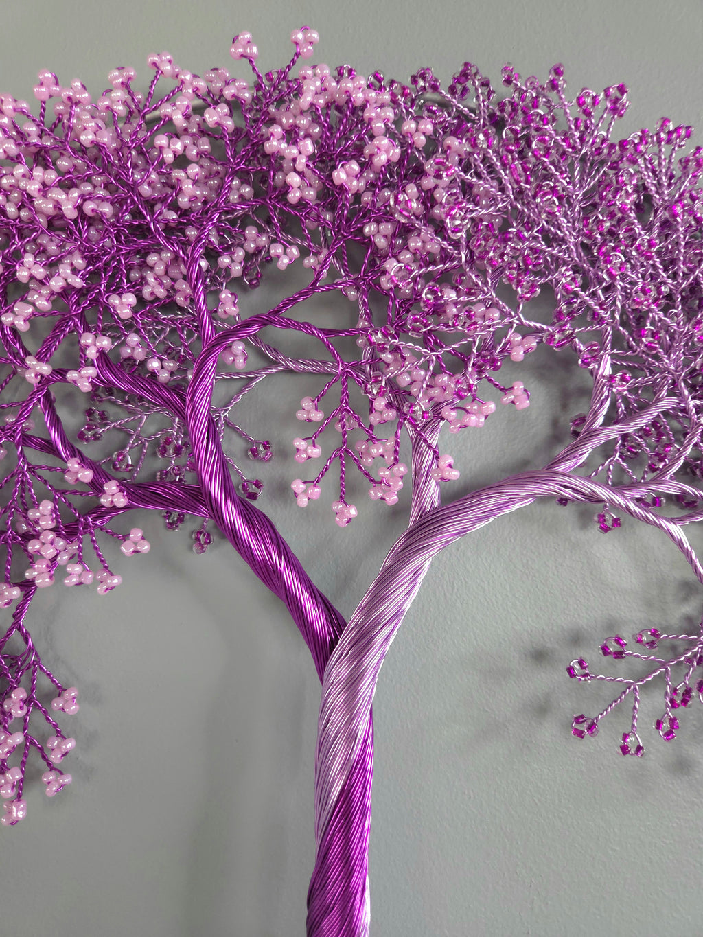 Decorative purple tree with pink berries on a gray background
