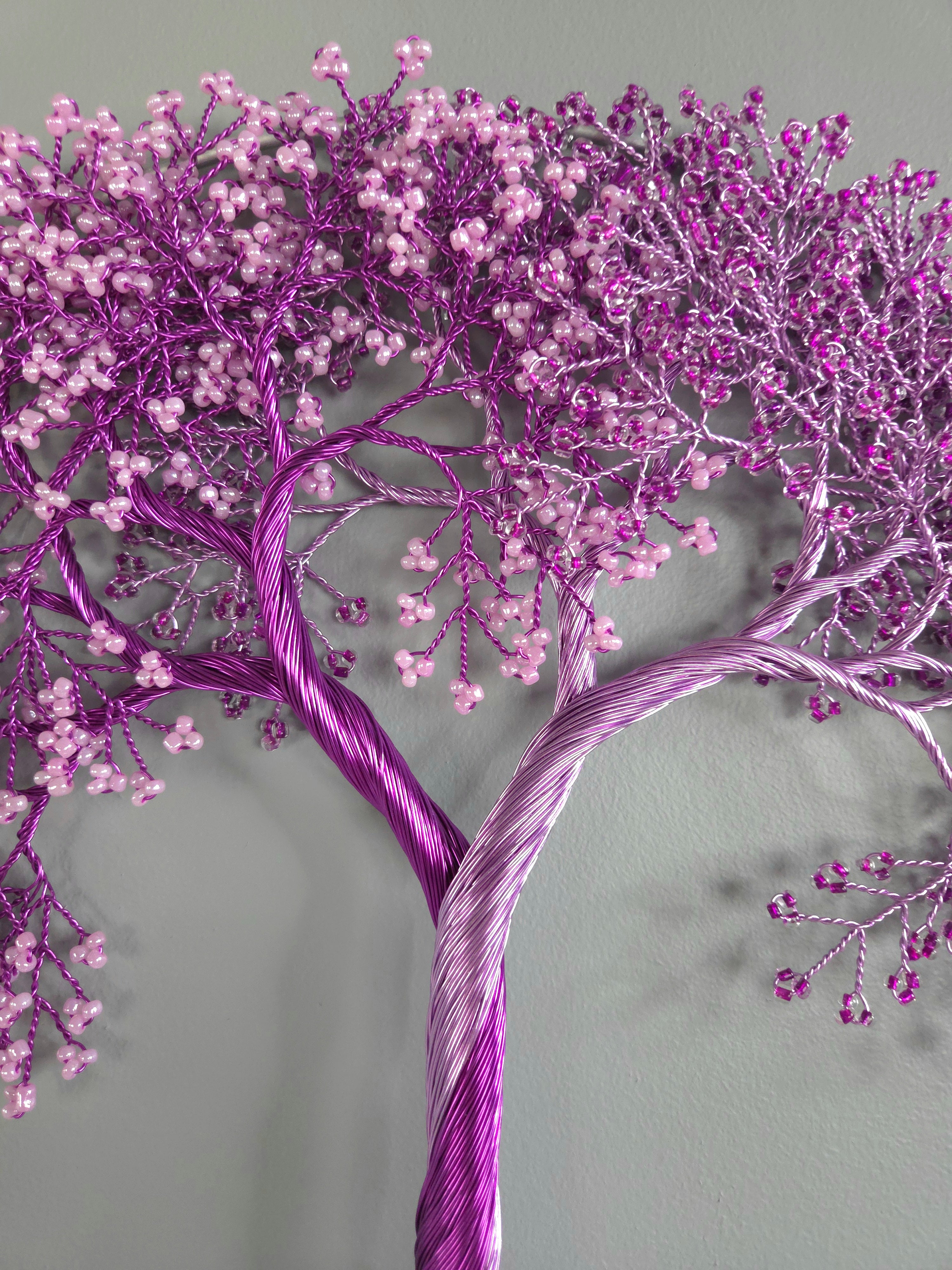 Decorative purple tree with pink berries on a gray background