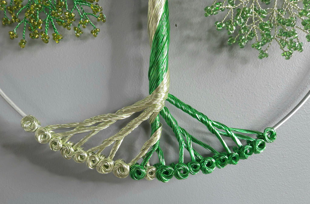 Close-up of a green beaded necklace on a gray background
