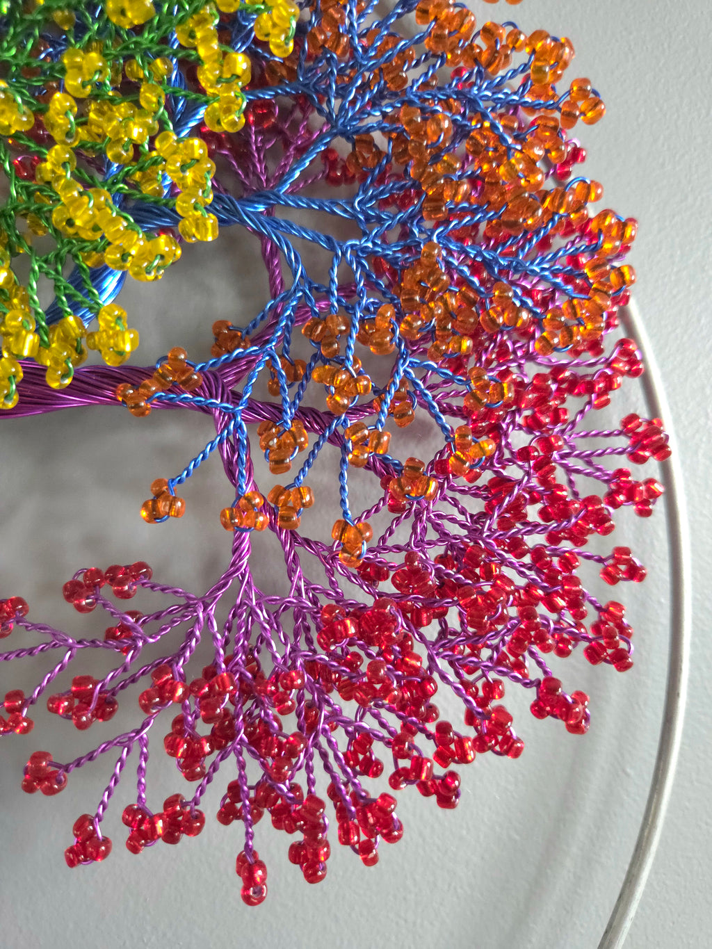 Colorful beaded branches on a white plate