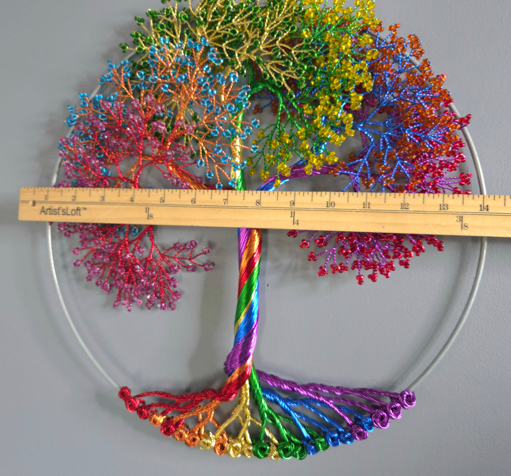 Colorful coral-like structure with a ruler for scale on a gray background