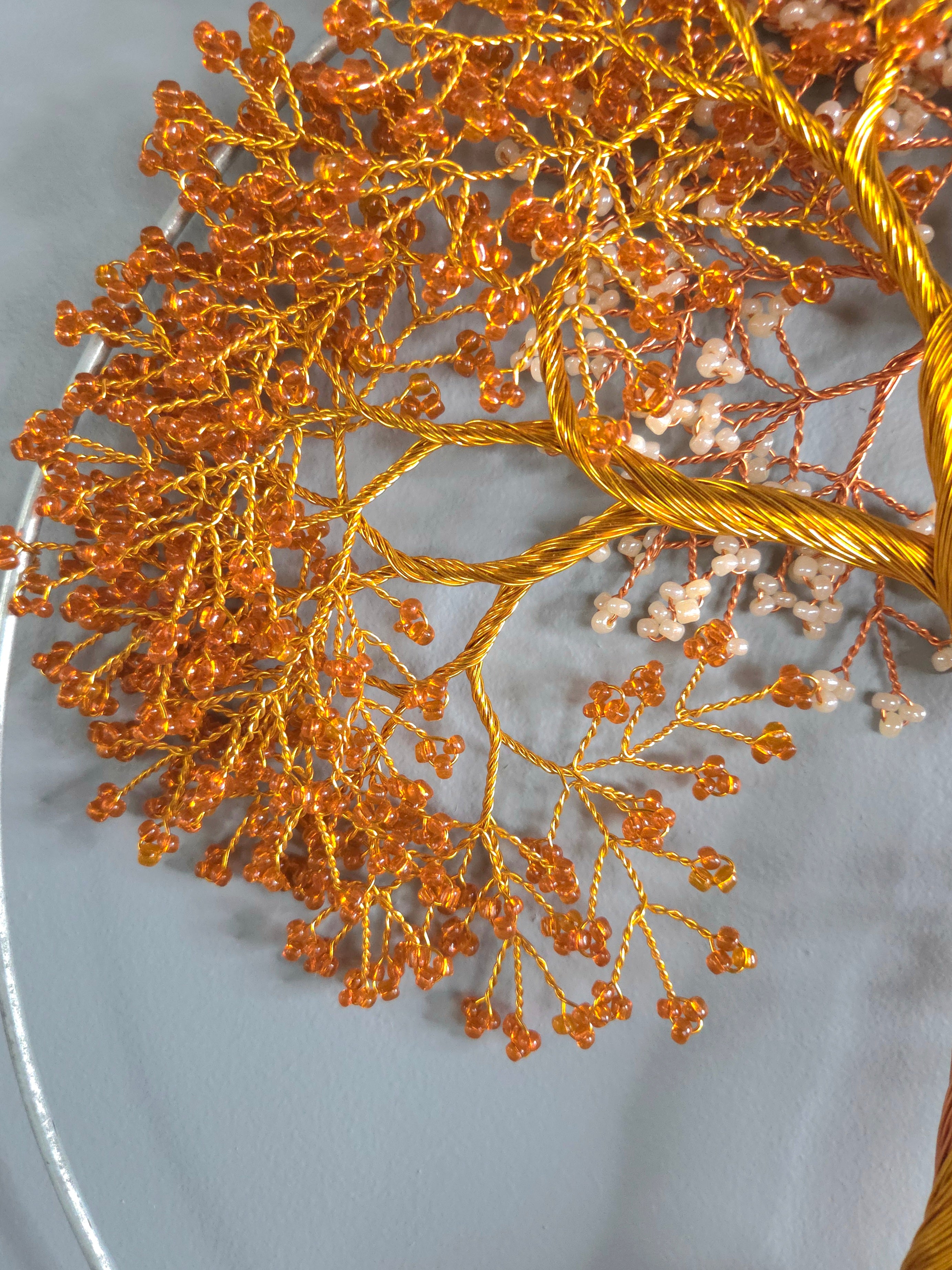 Close-up of a decorative branch with small flowers on a light gray background