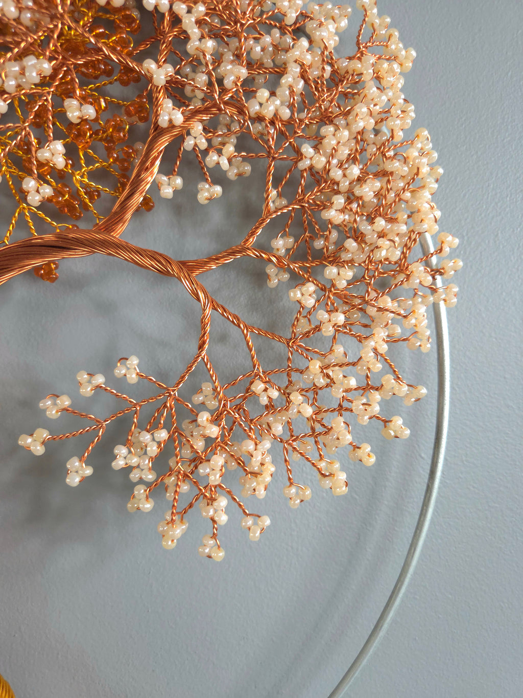 Decorative branch with small white berries on a gray background