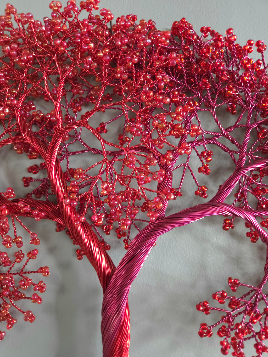 Decorative red beaded tree on a gray background