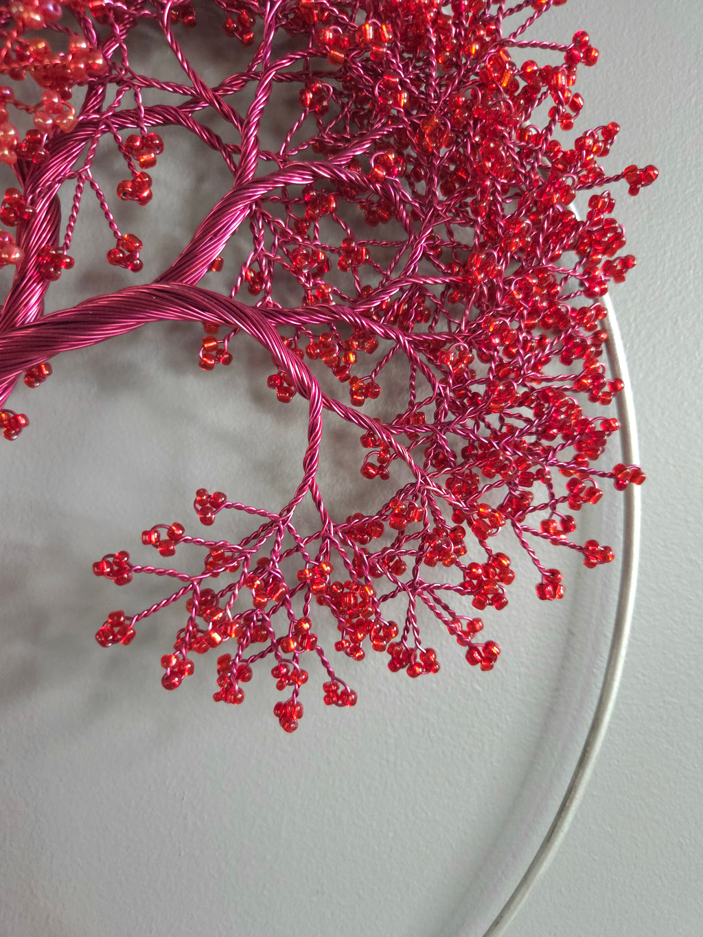Close-up of red decorative branch on a light gray background