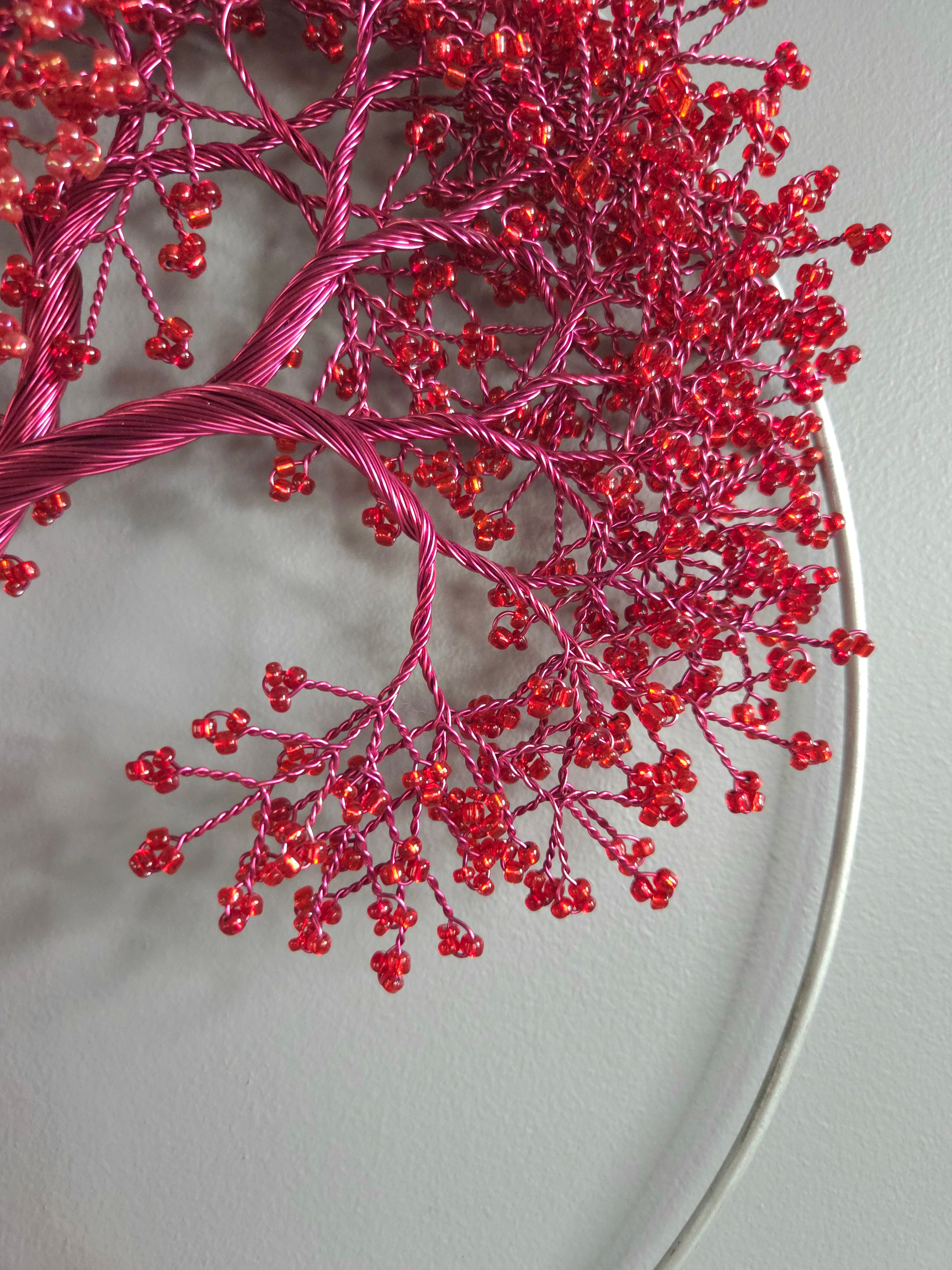 Close-up of red decorative branch on a light gray background