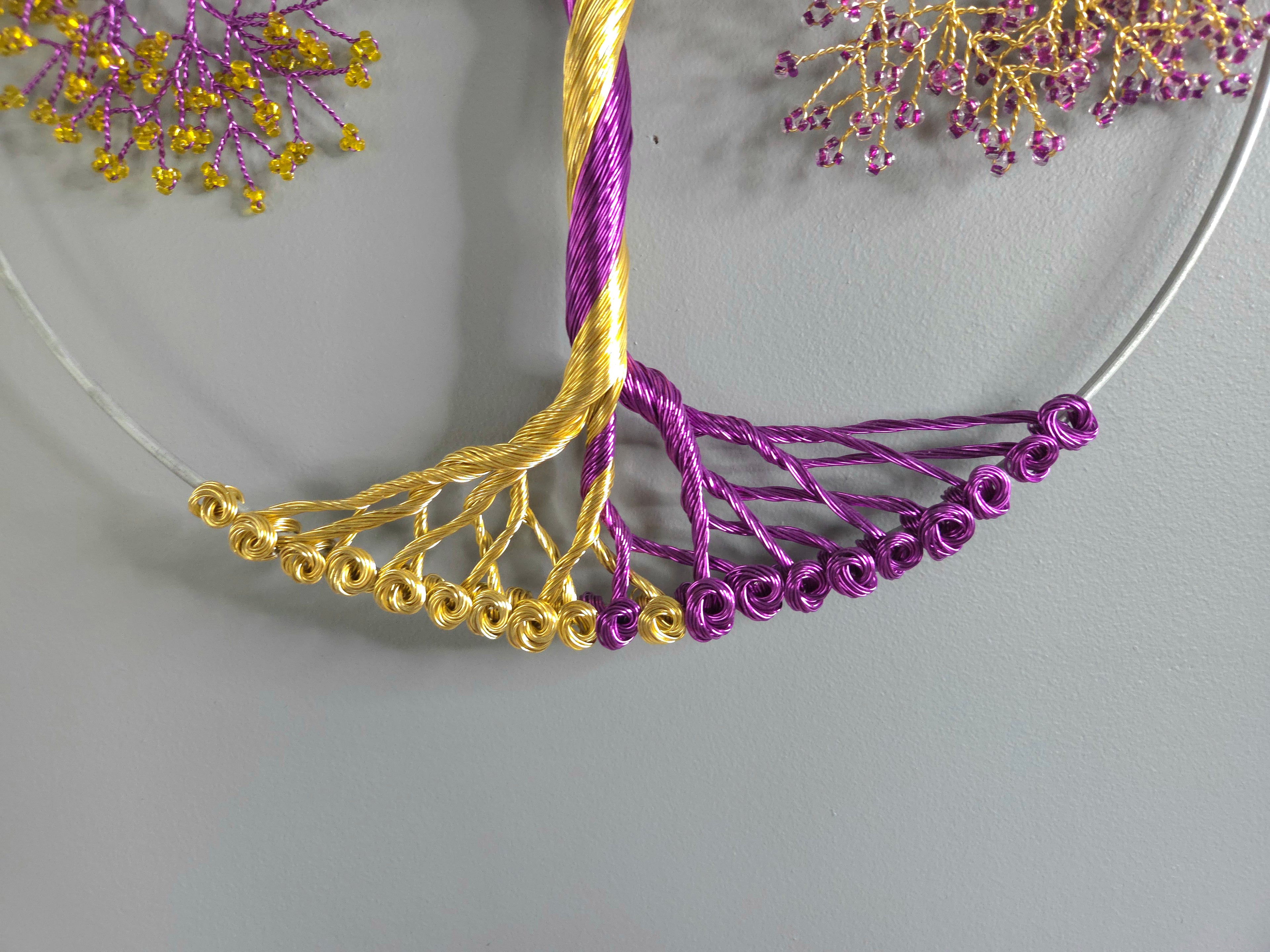 Close-up of a gold and purple decorative item on a gray background