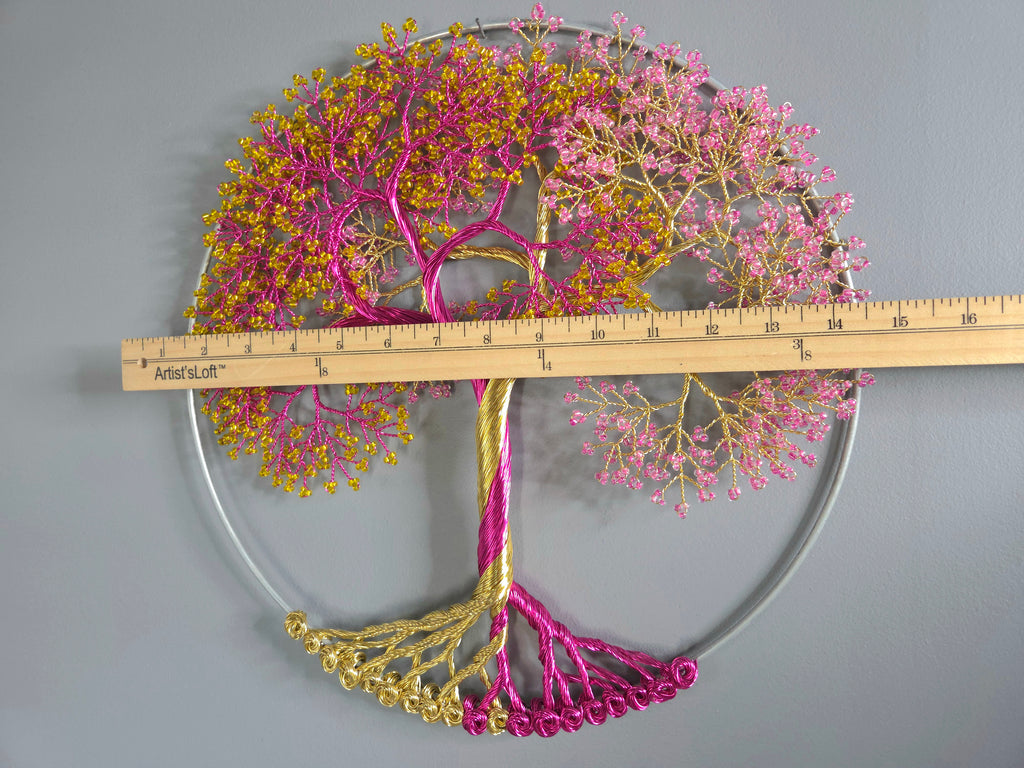 Decorative wall art of a tree with pink and gold branches, measured against a ruler.