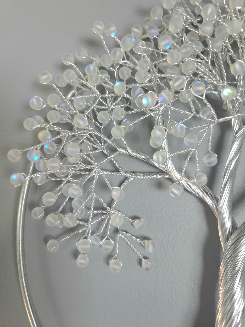 Decorative silver tree wall art on a gray background