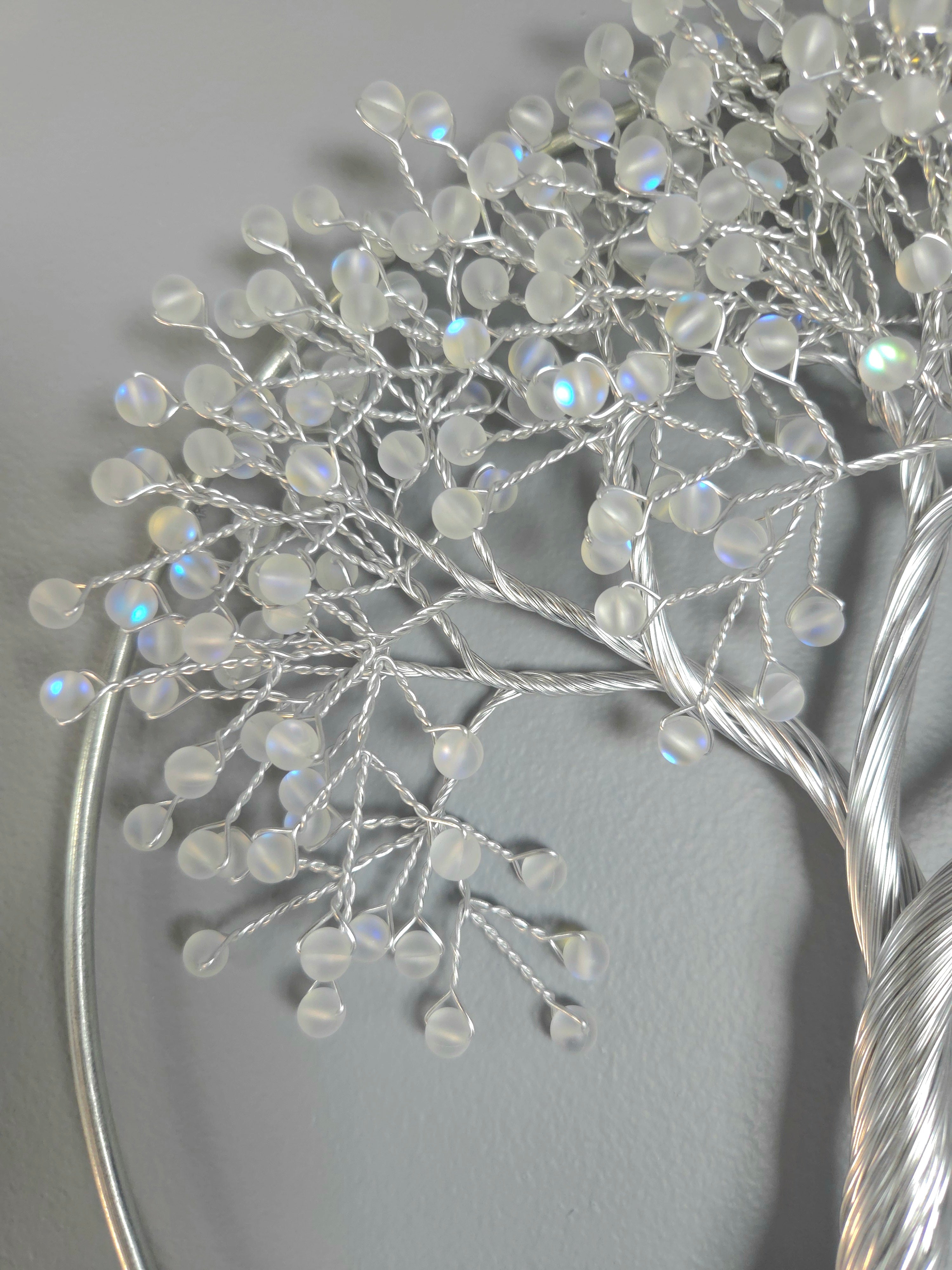 Decorative silver tree wall art on a gray background