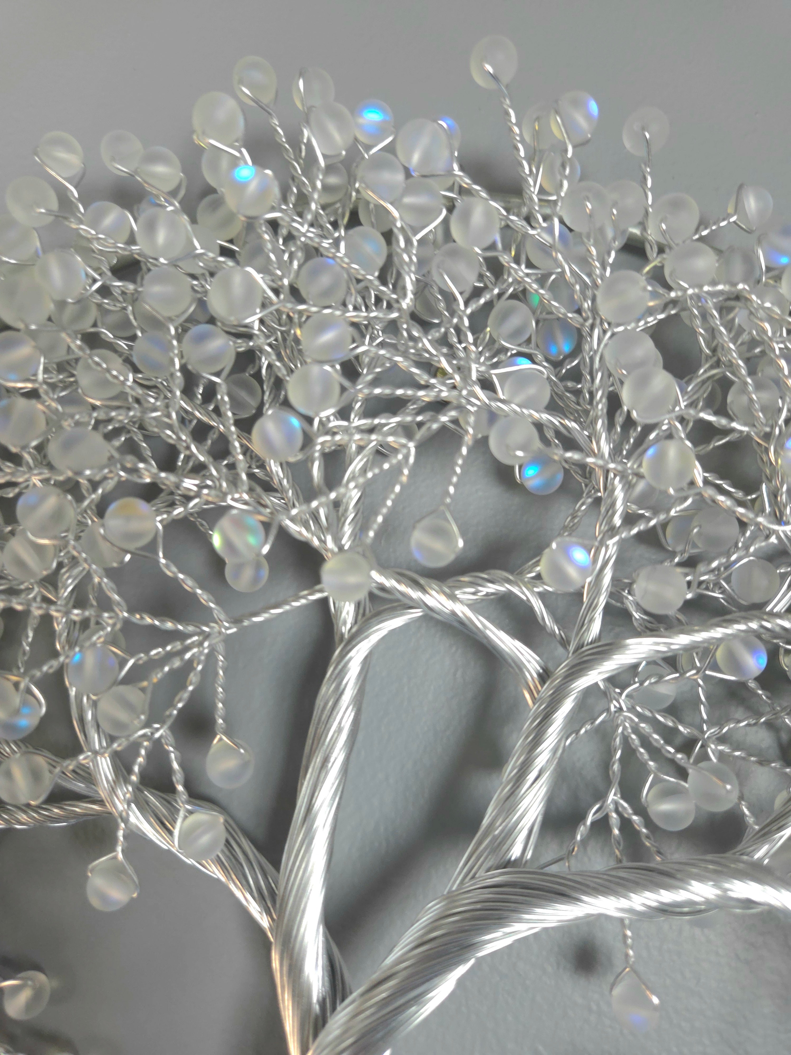 Decorative silver tree wall art on a gray background