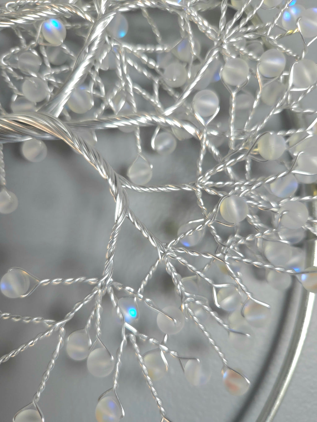 Decorative silver tree wall art on a gray background