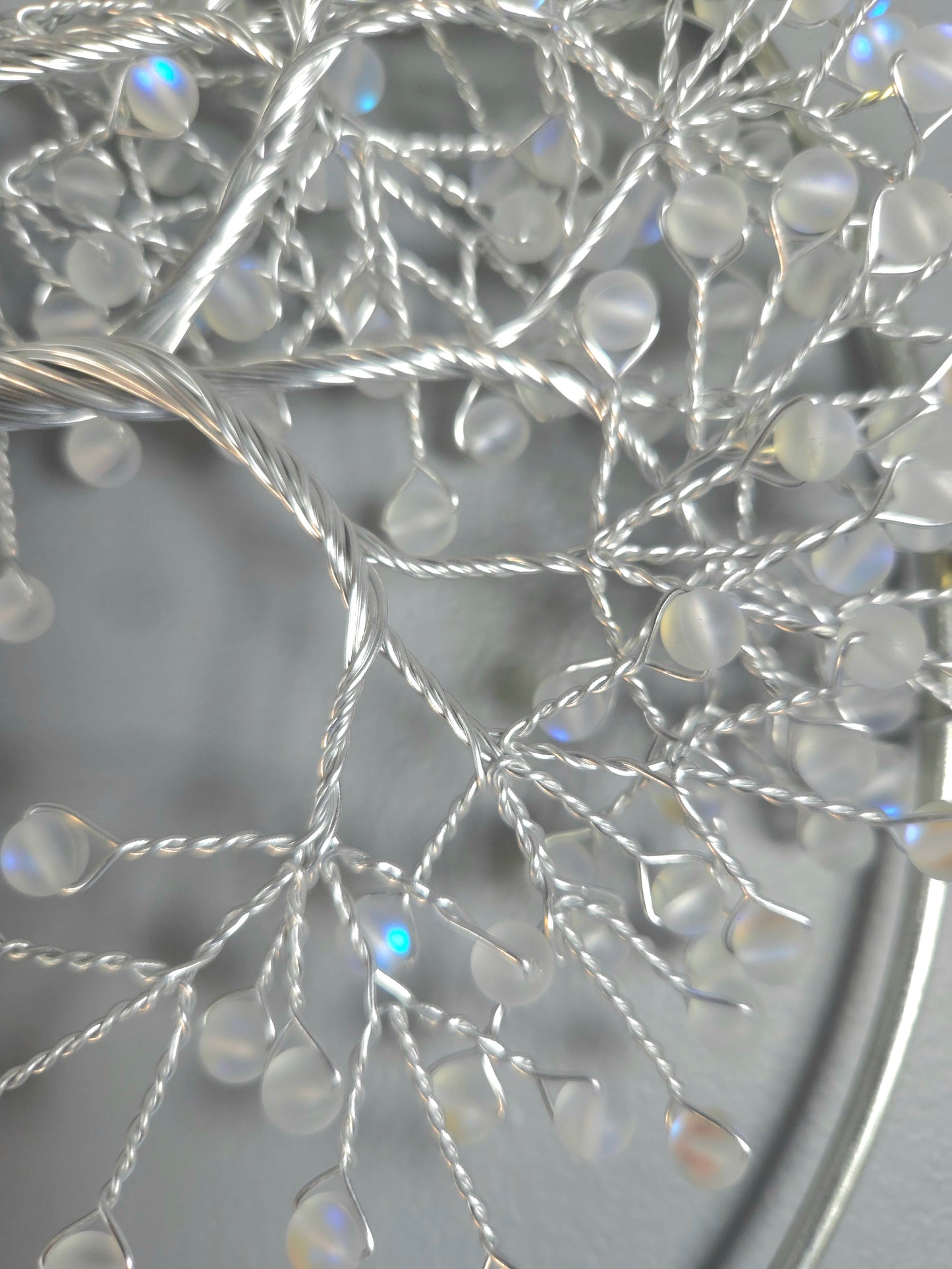 Decorative silver tree wall art on a gray background