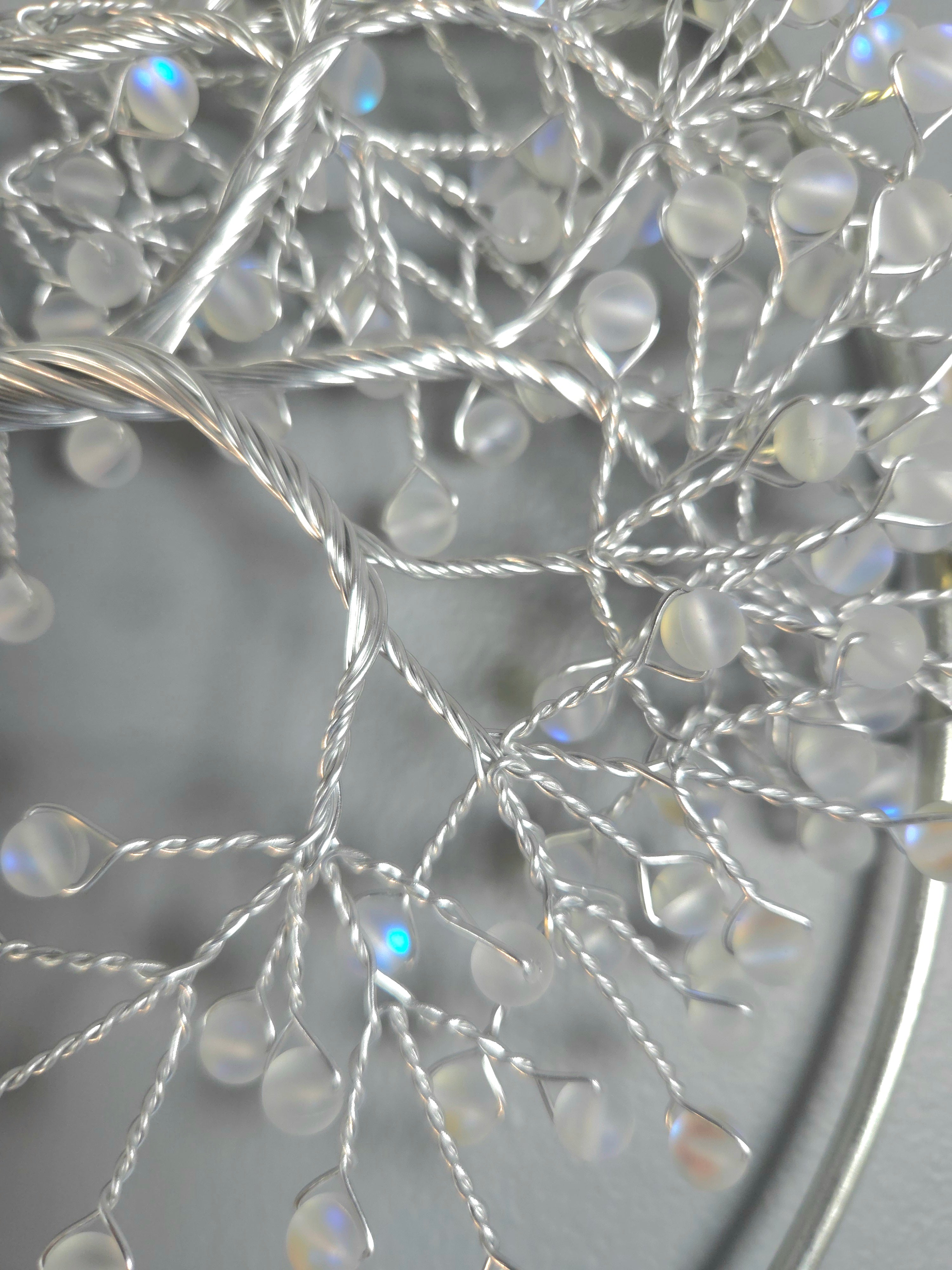 Decorative silver tree wall art on a gray background