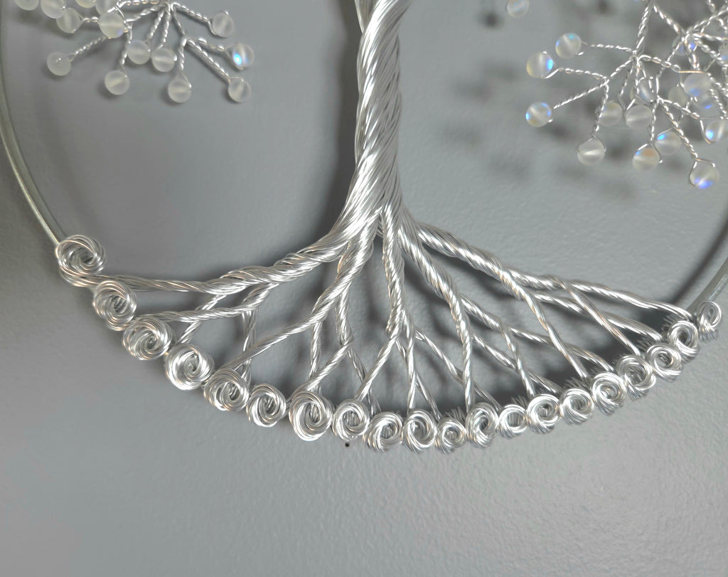Decorative silver tree wall art on a gray background
