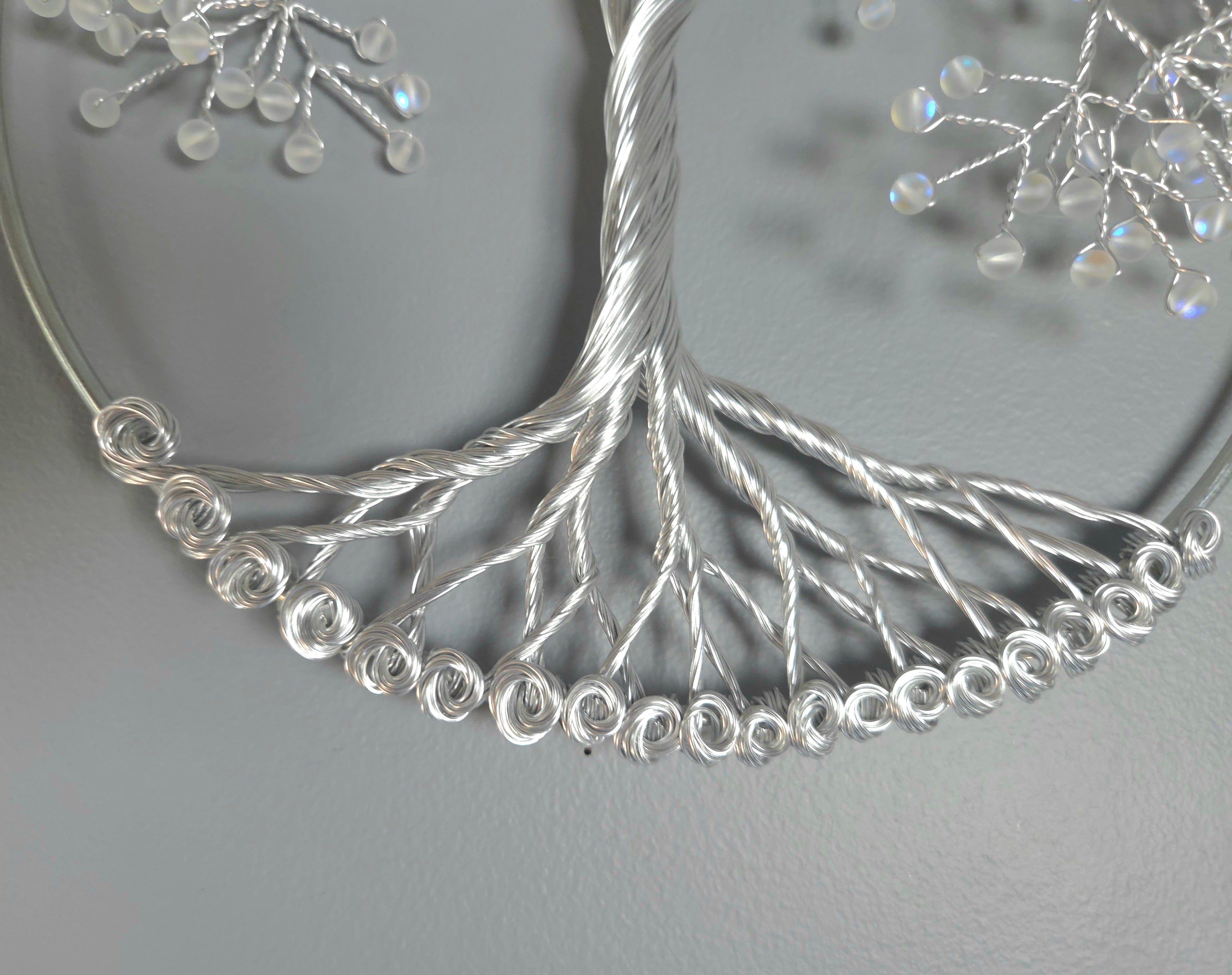 Decorative silver tree wall art on a gray background