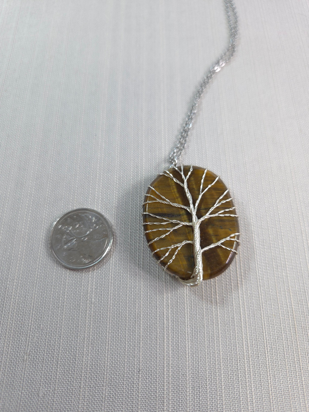 Necklace with a circular pendant on a light gray background