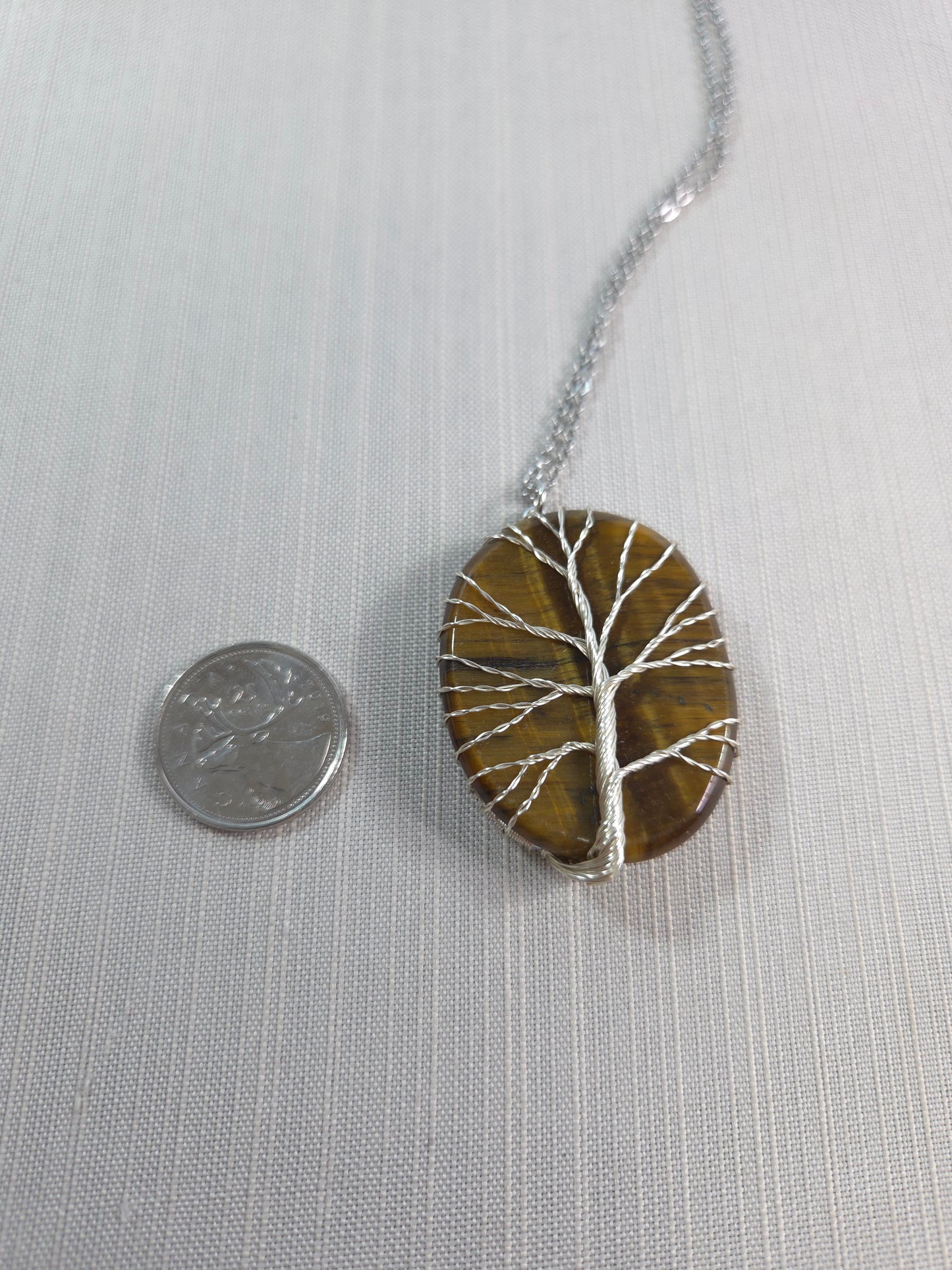 Necklace with a circular pendant on a light gray background