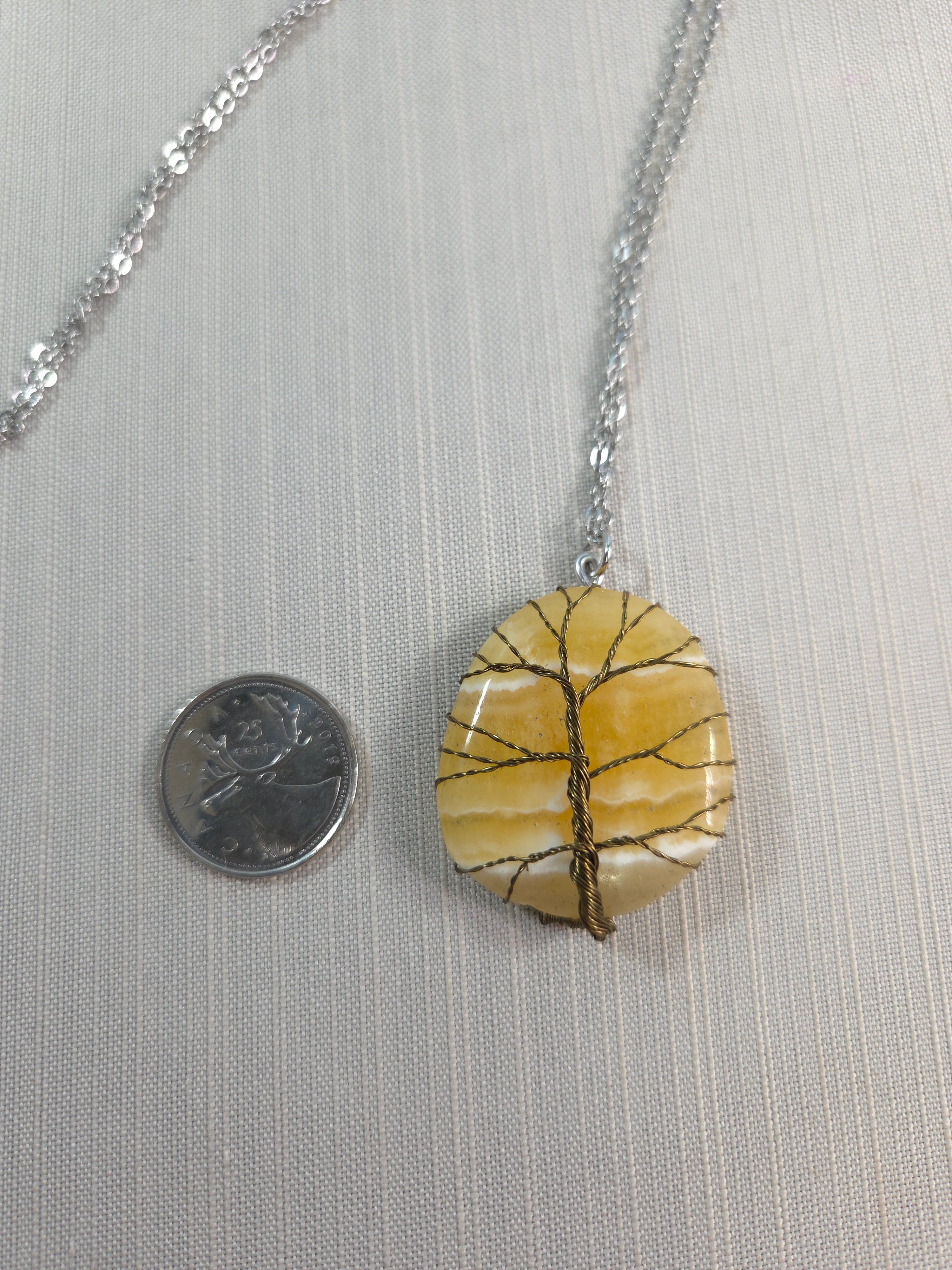 Necklace with a circular pendant on a neutral background