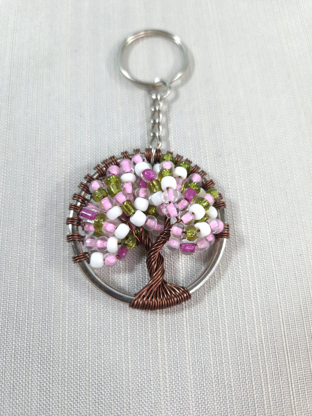Keychain with beaded tree design on a white background