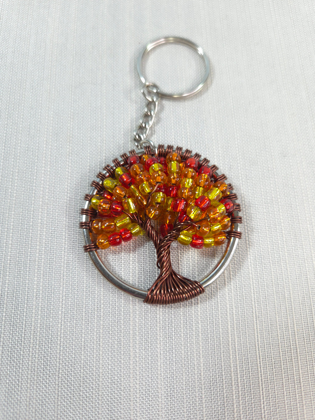 Keychain with beaded tree design on a white background