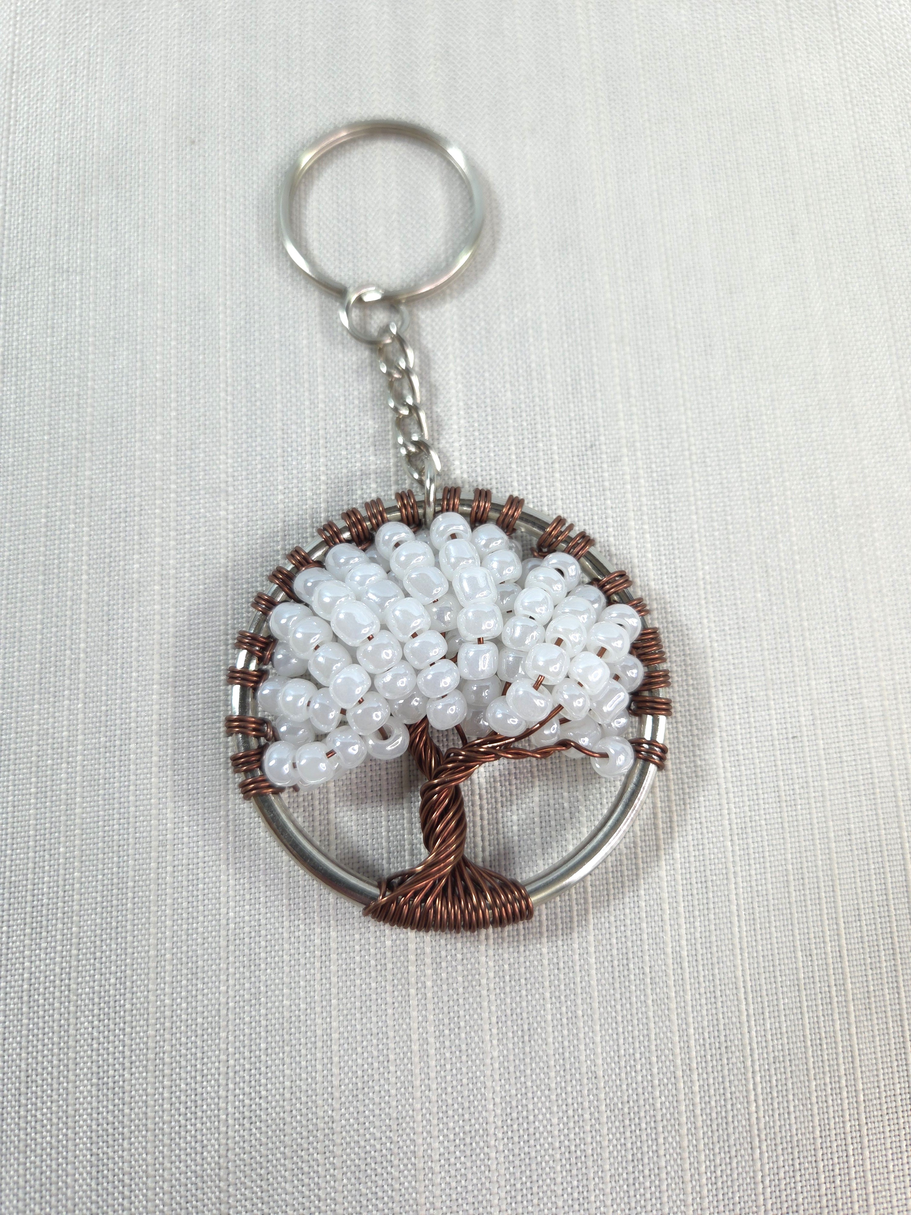 Keychain with beaded tree design on a white background