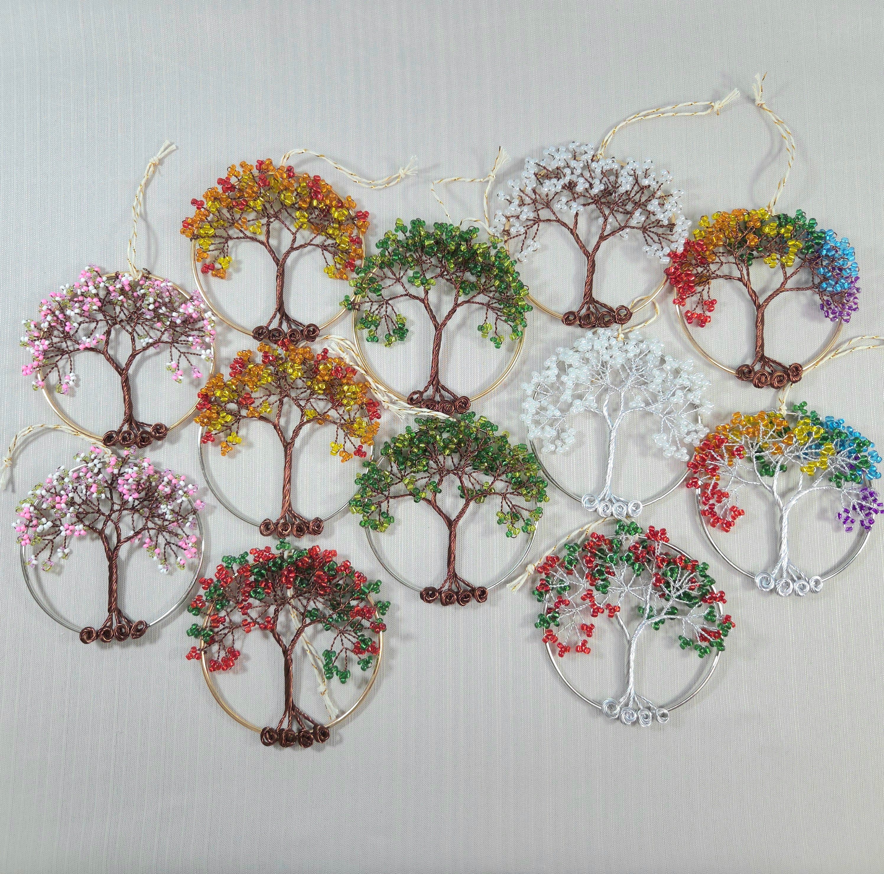 Decorative wall art with colorful tree designs on a light gray background