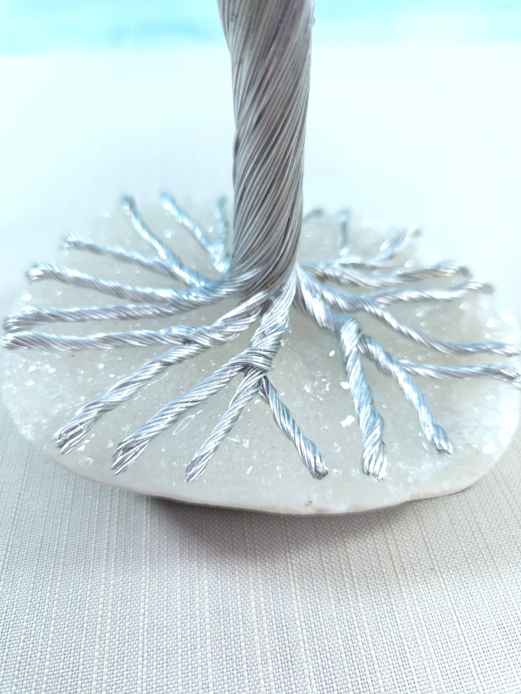 Close-up of a decorative item with metallic strands on a light background