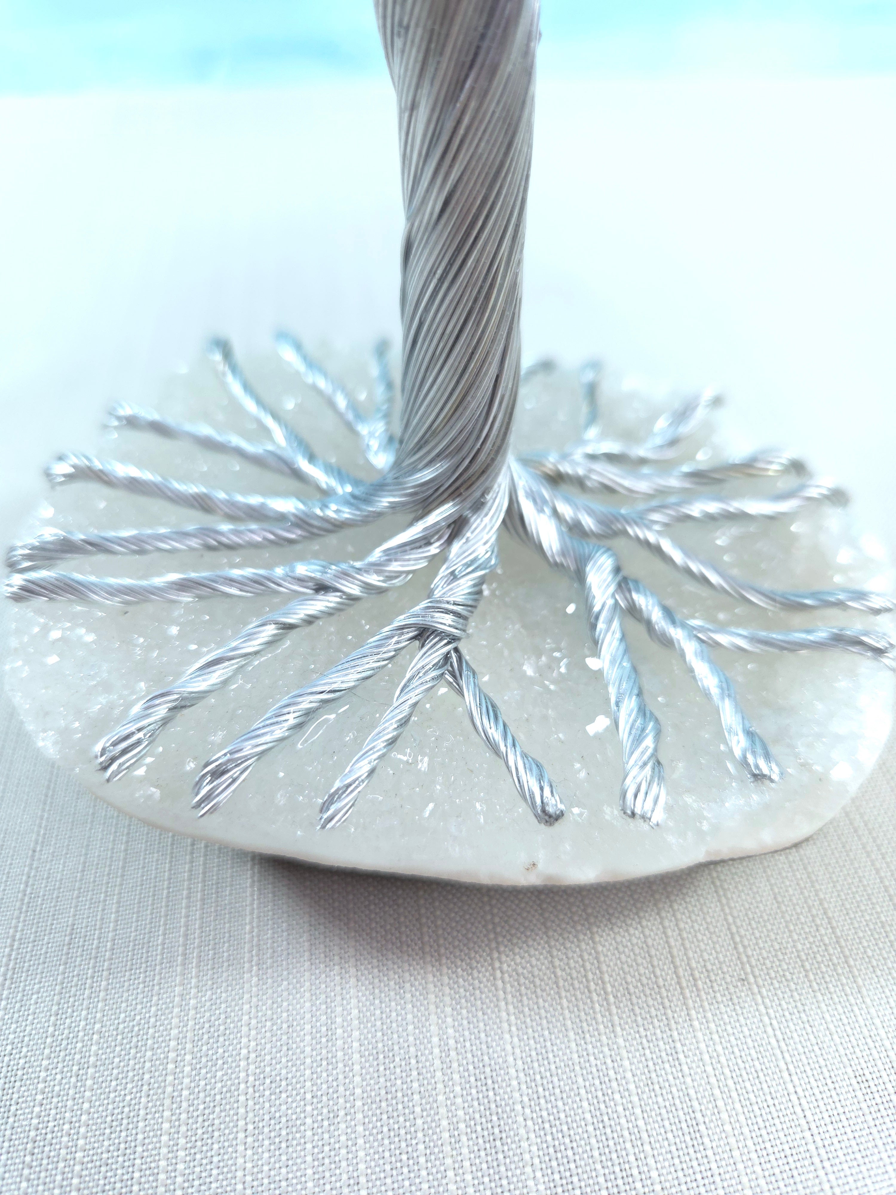 Close-up of a decorative item with metallic strands on a light background