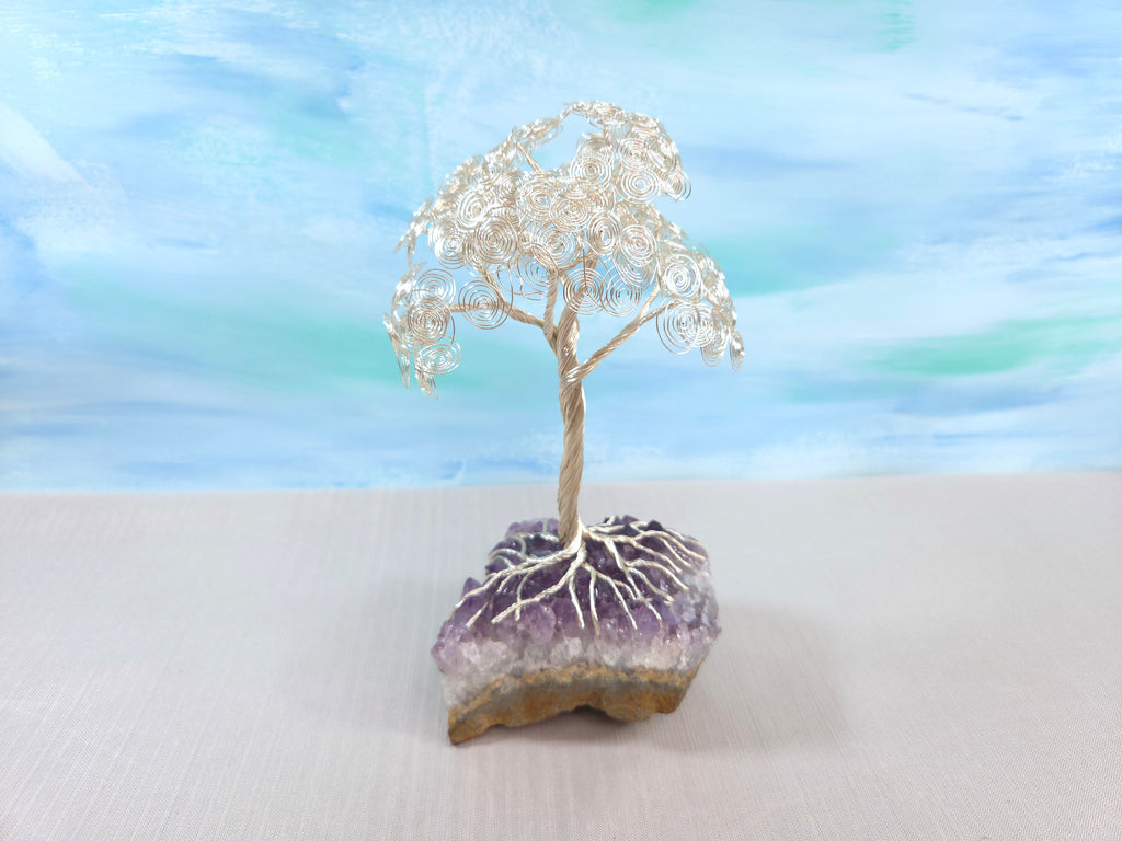 Decorative tree made of wire on a rock with a blurred background