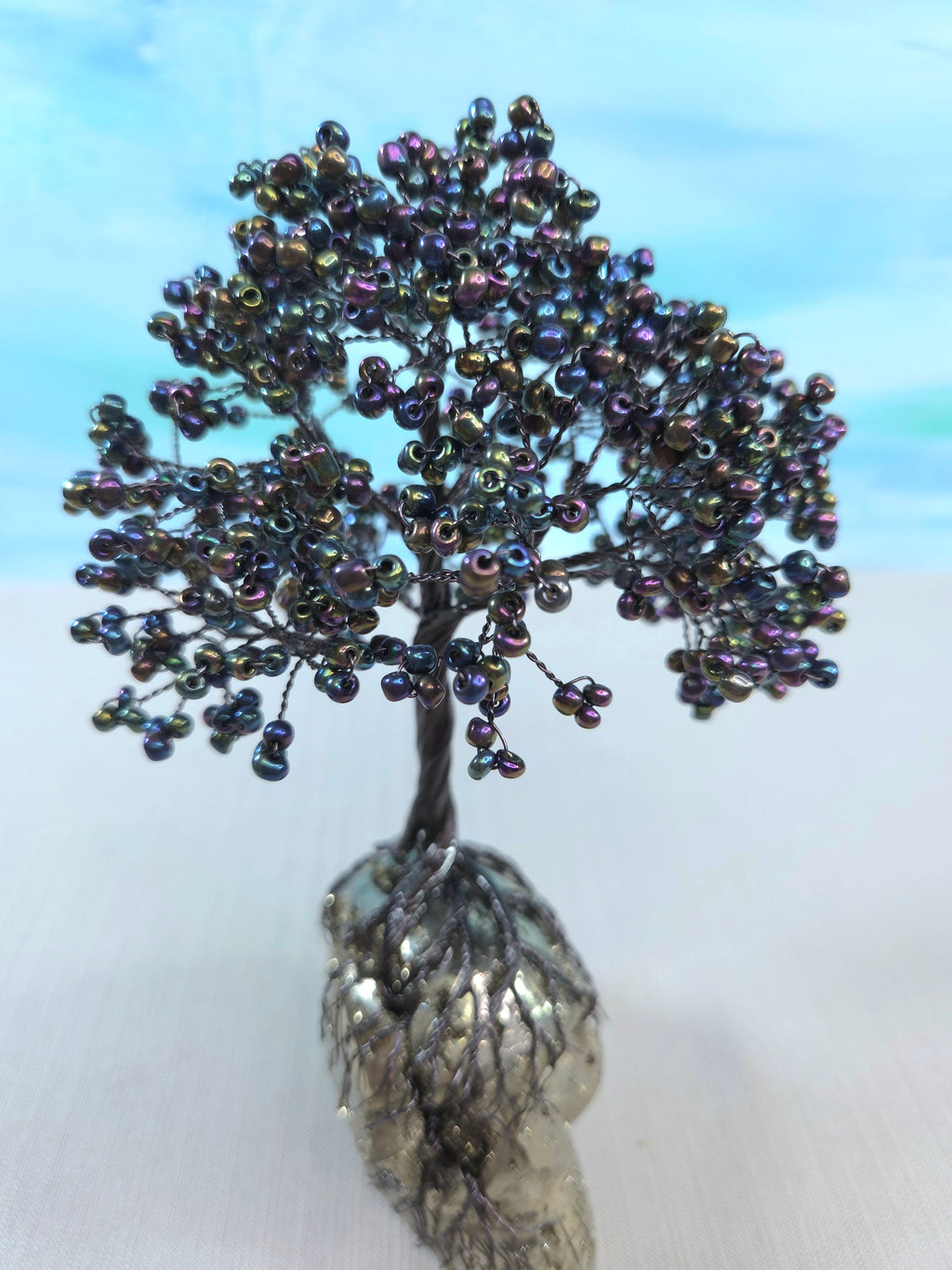 Decorative tree made of beads on a white background