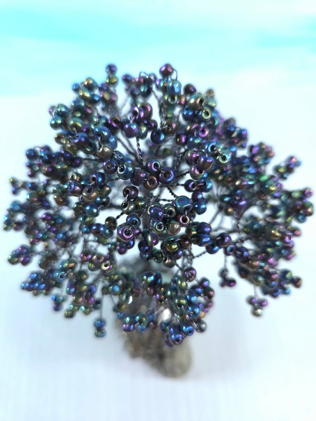 Beaded flower accessory on a light blue background