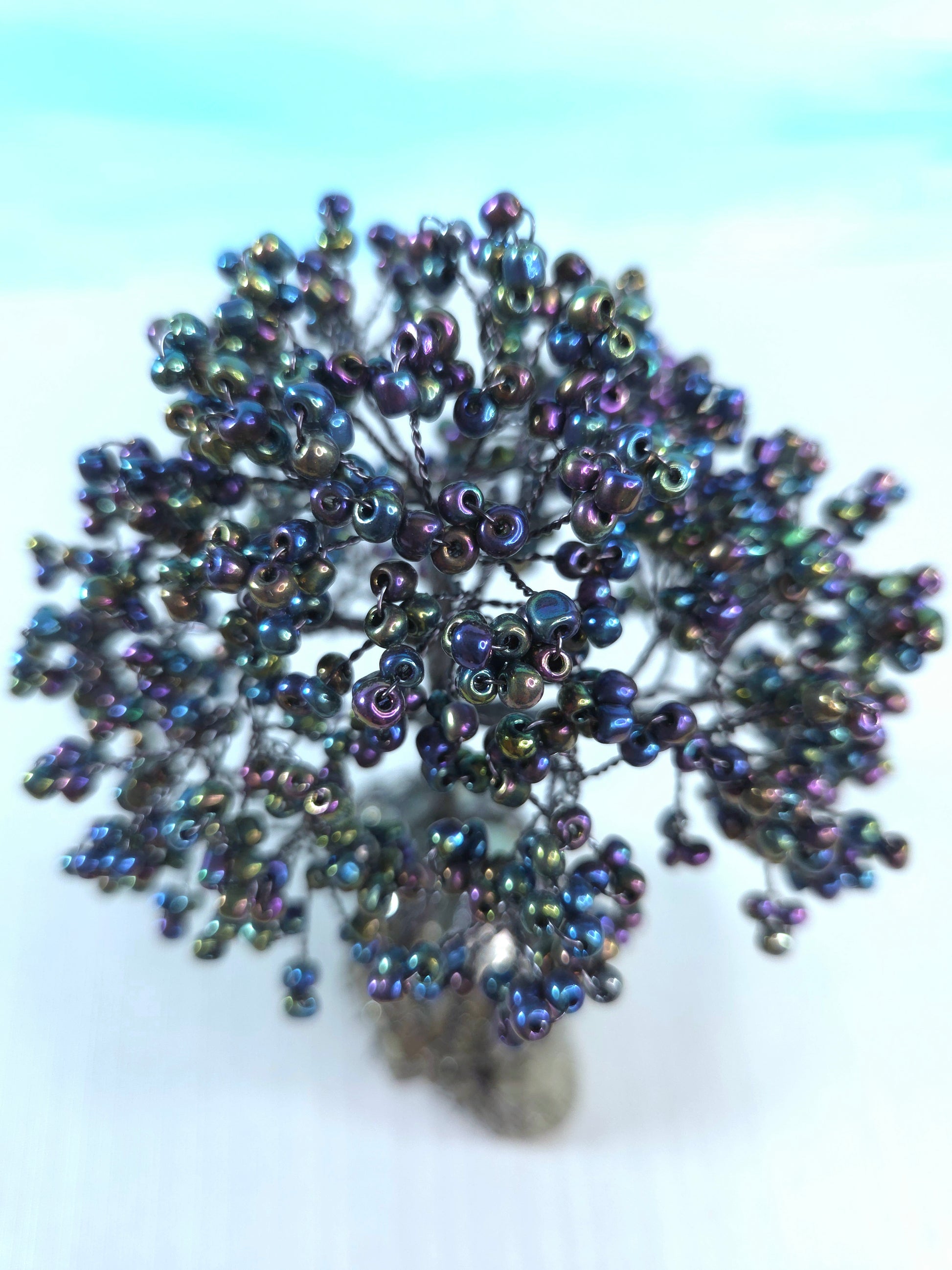 Beaded flower accessory on a light blue background